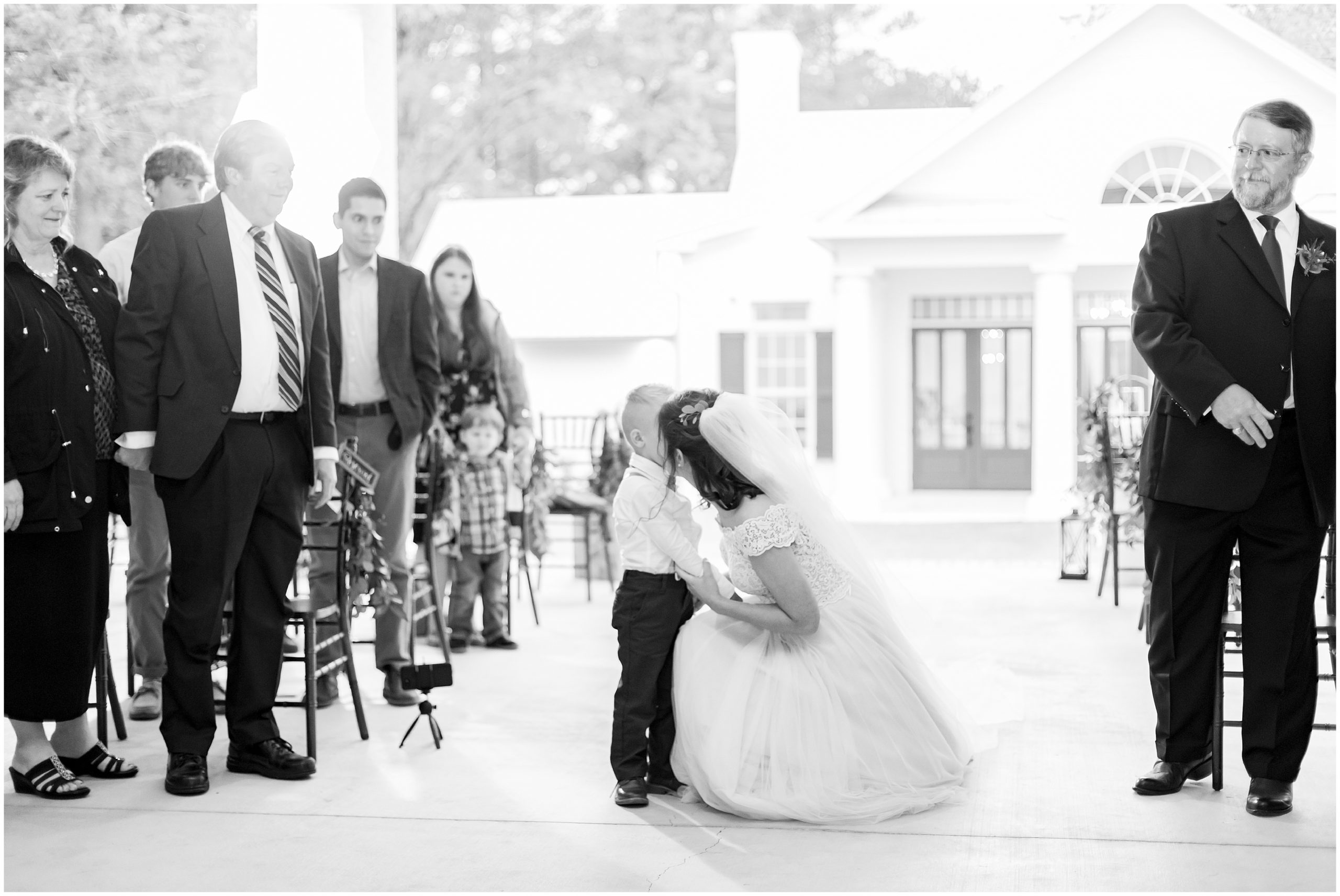 bride kisses ring bearer during photos in Alabama