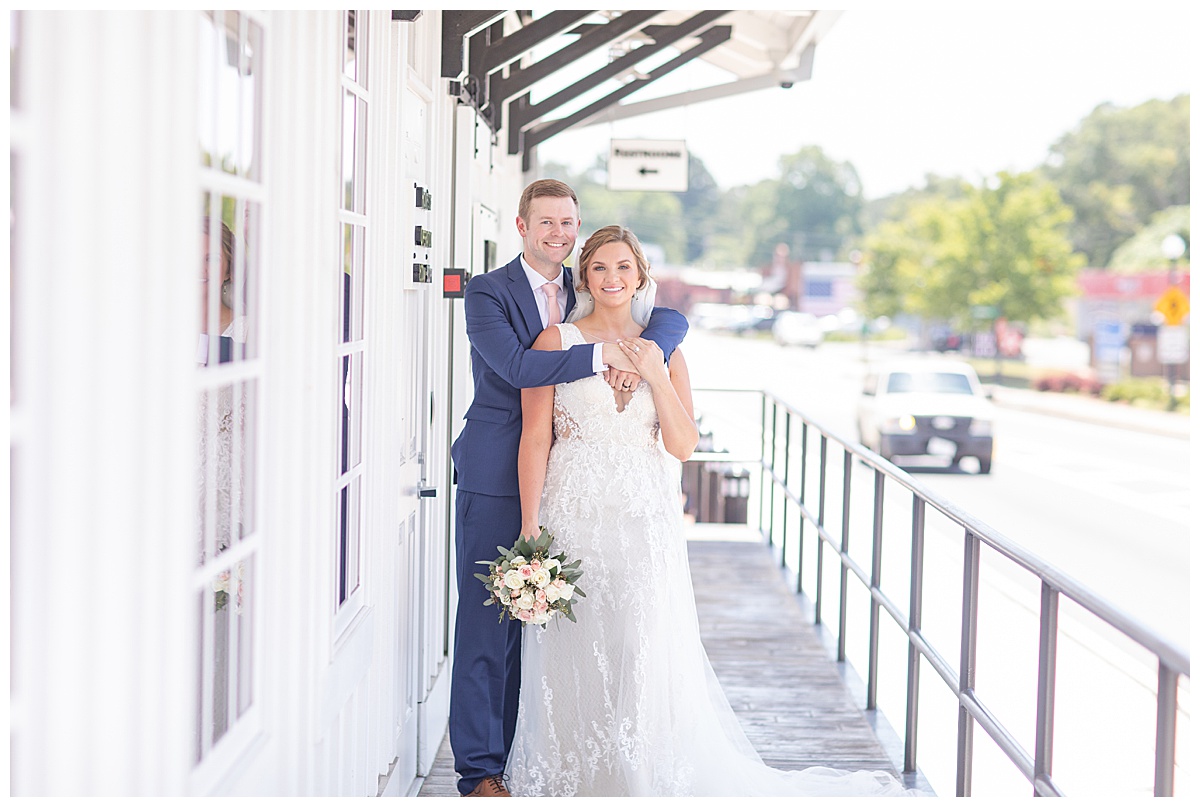 newlyweds pose alongside The Conservatory at Waterstone during wedding portraits 