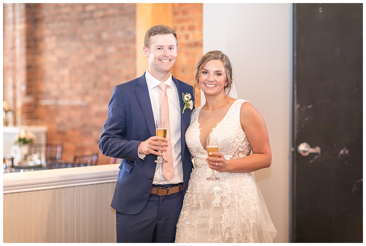 newlyweds pose with champagne during Acworth GA wedding reception
