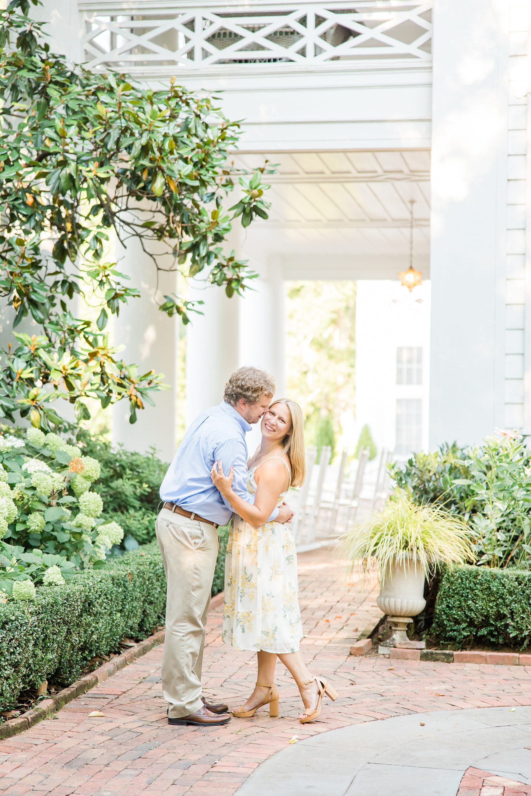 bride and groom kiss on patio of the Duke Mansion
