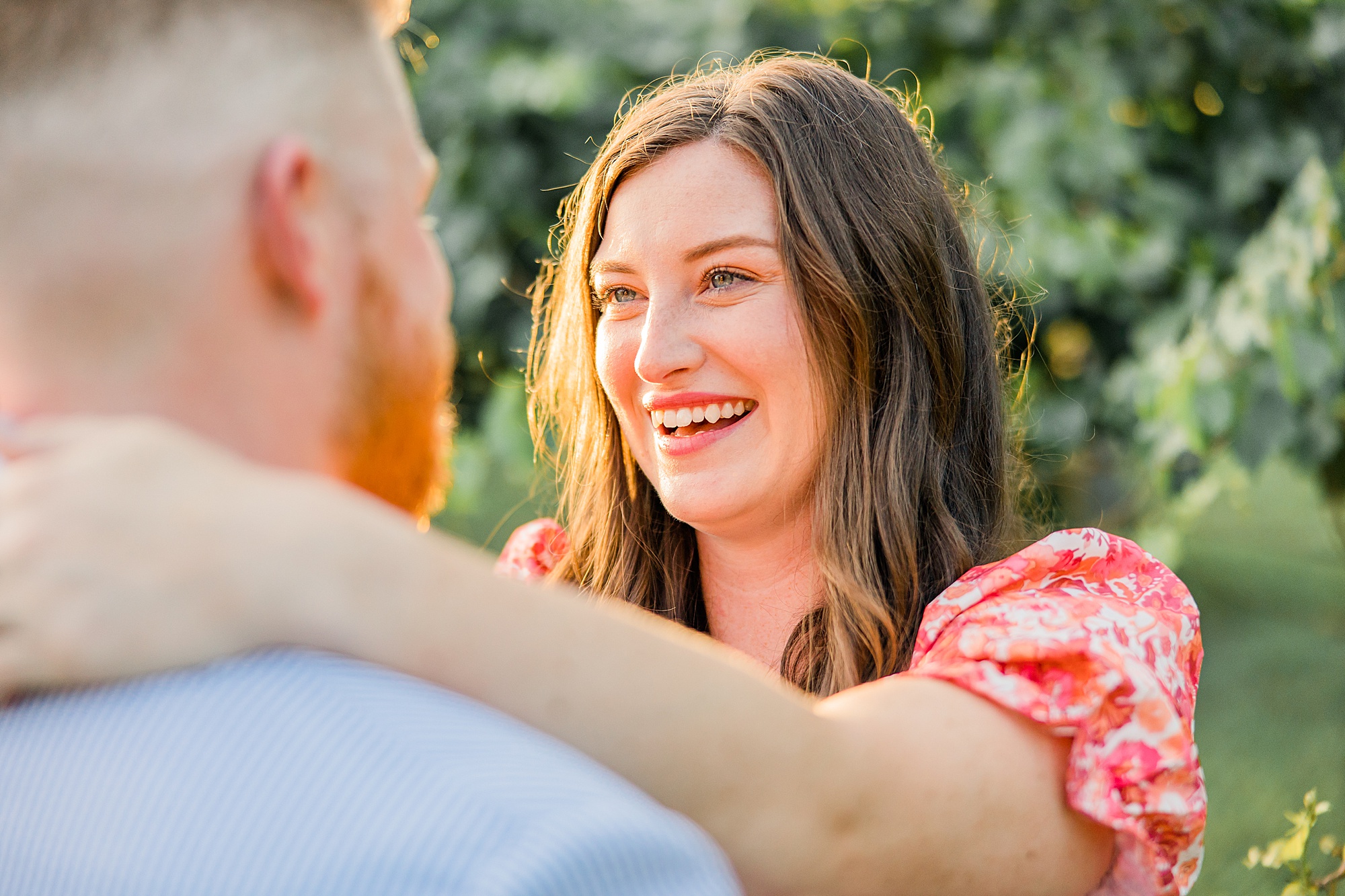 bride smiles at groom during proposal portraits