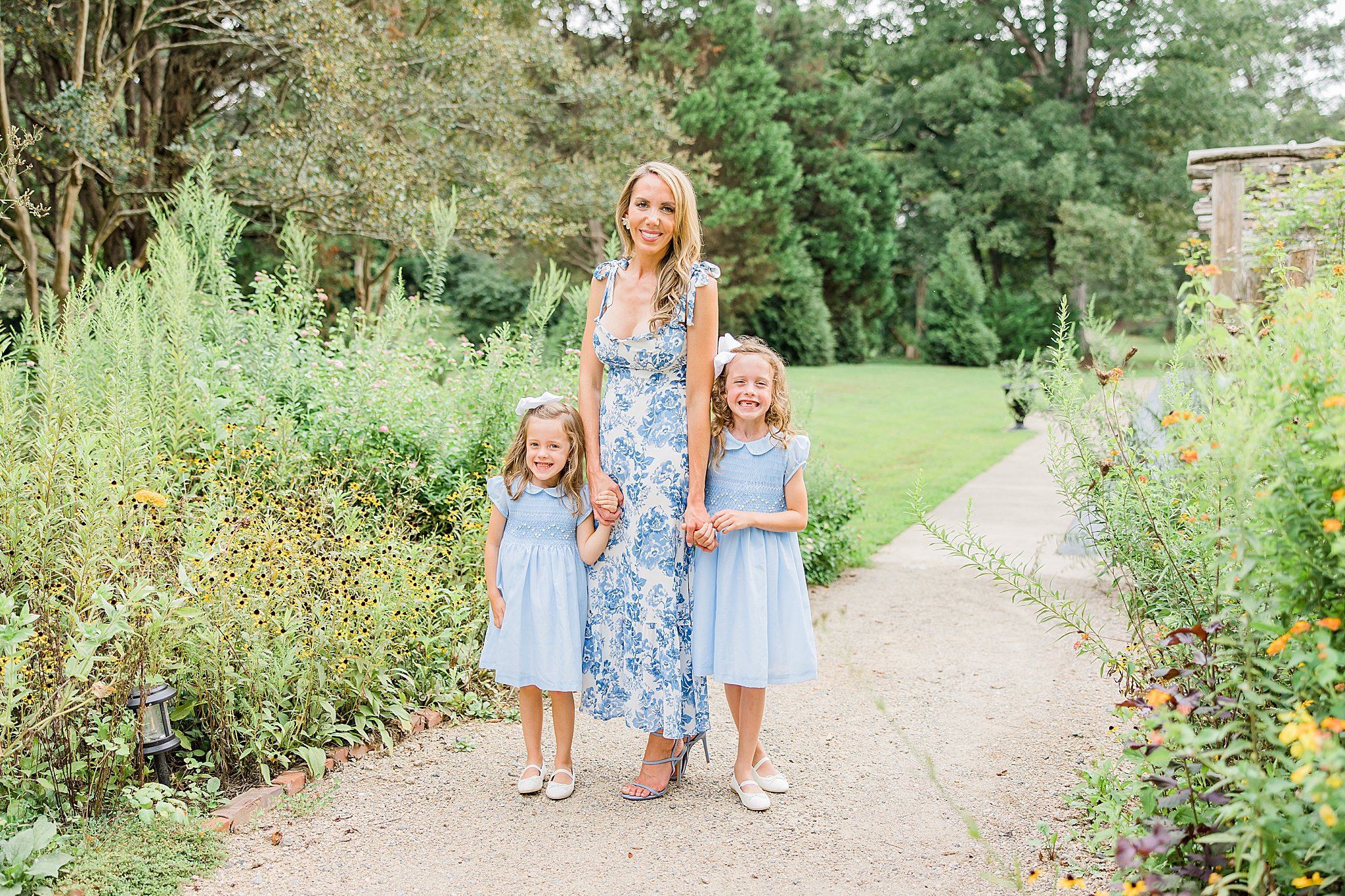mom poses with two daughters during fall mini sessions