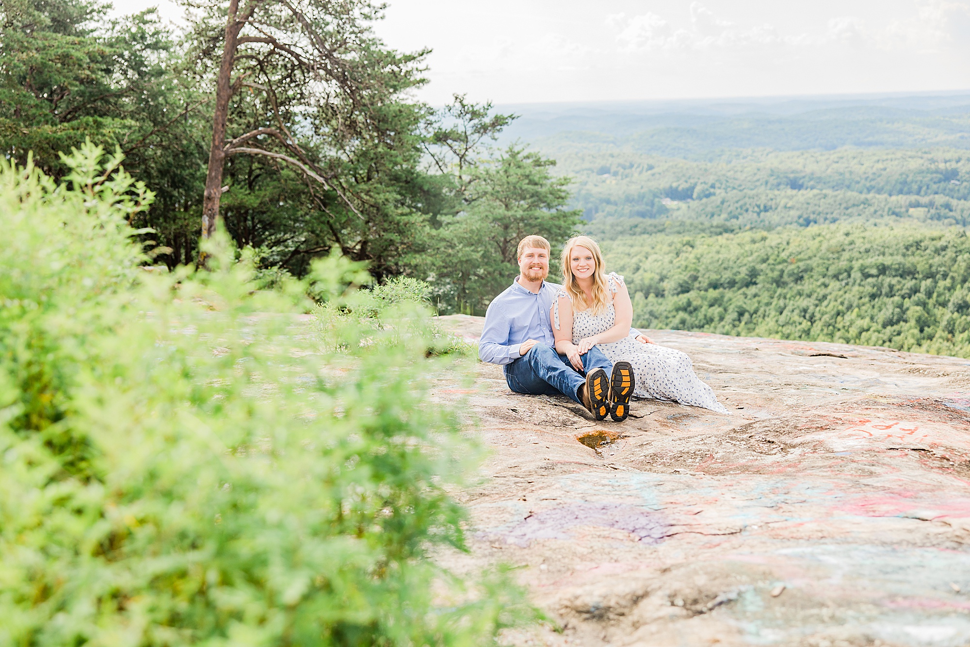 bride and groom sit on mountaintop in SC
