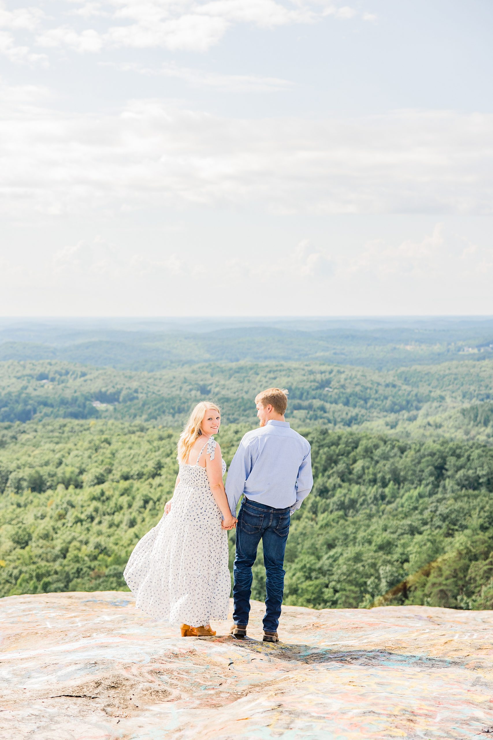 engaged couple stands on mountaintop during Bald Rock engagement session