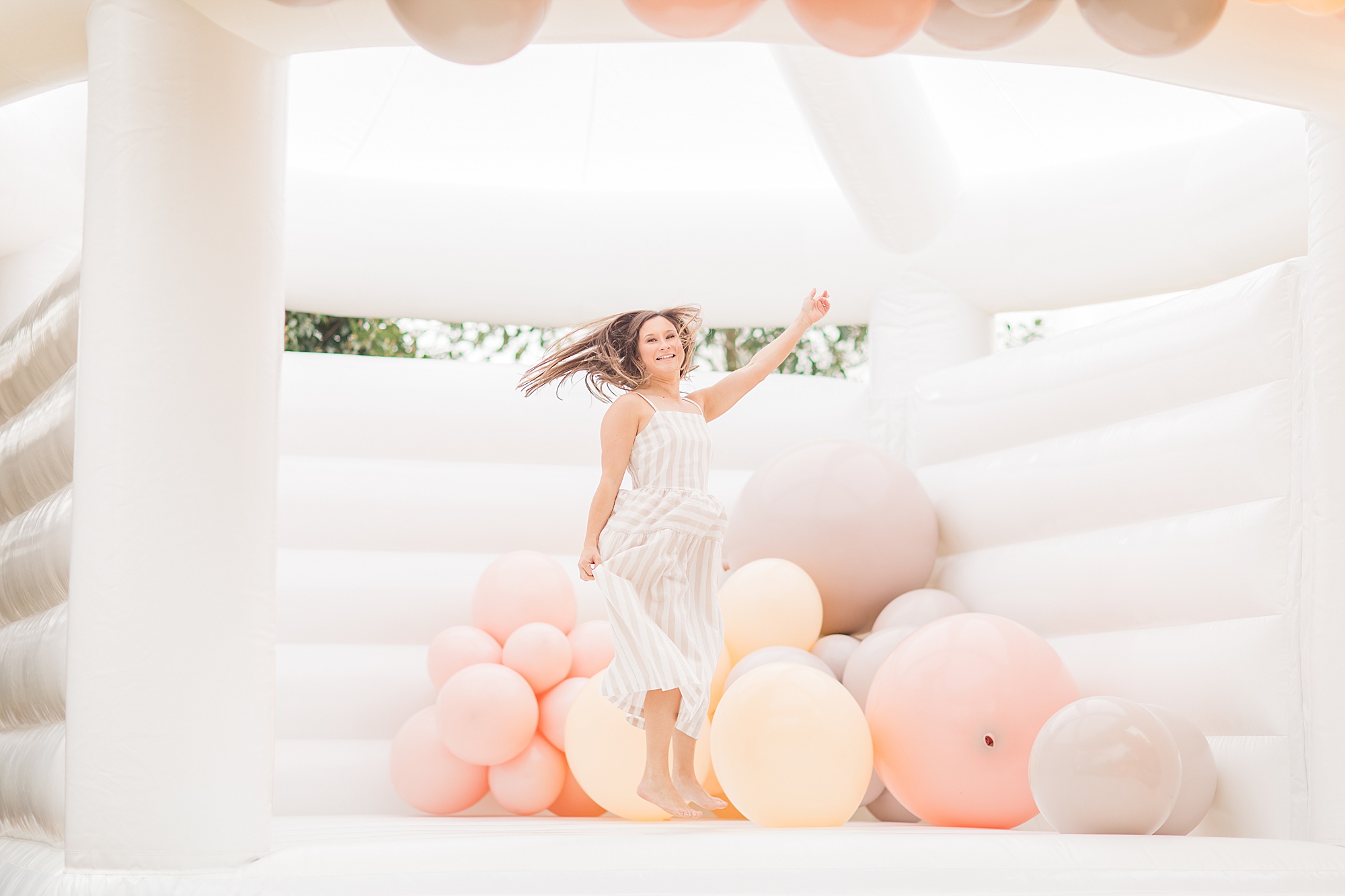woman bounces in ballon house from Posh Balloon