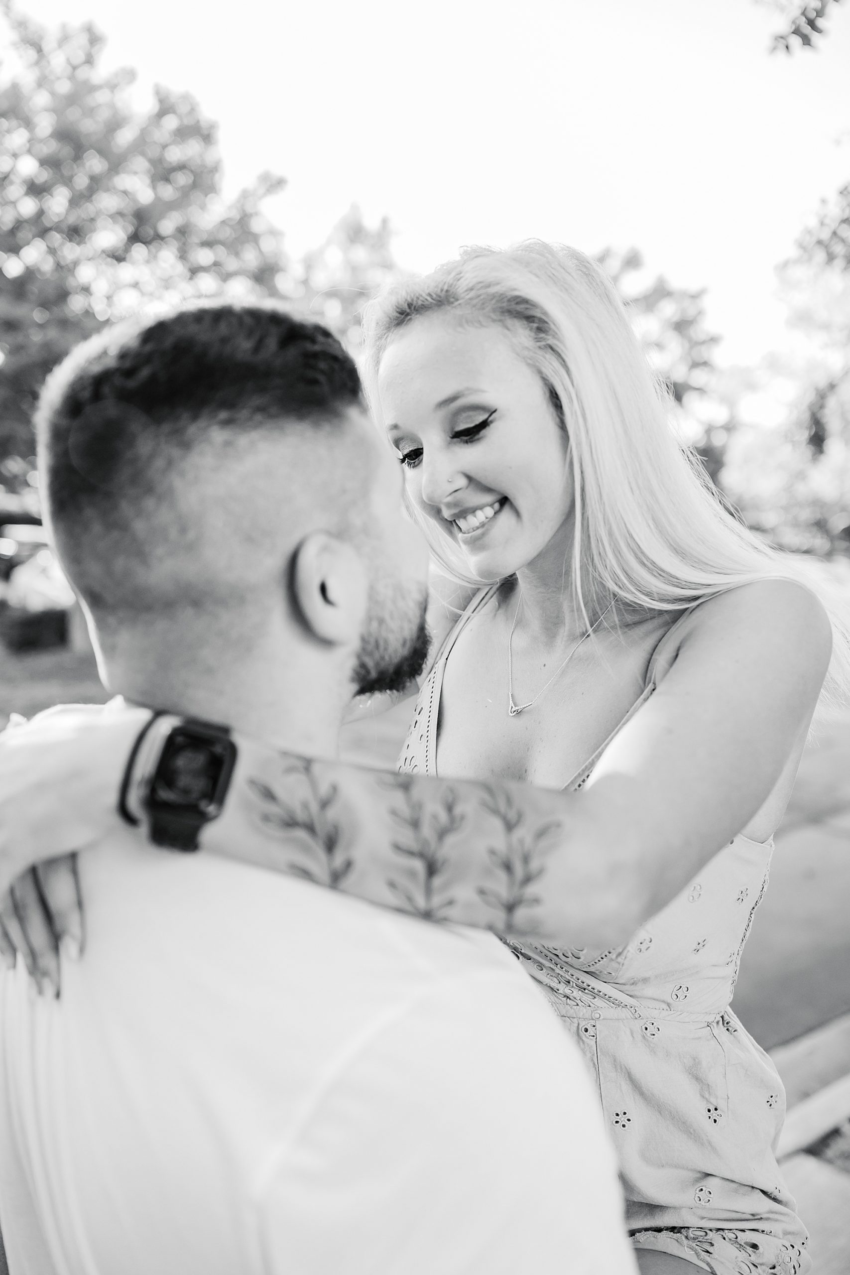 groom lifts bride during portraits after NC engagement