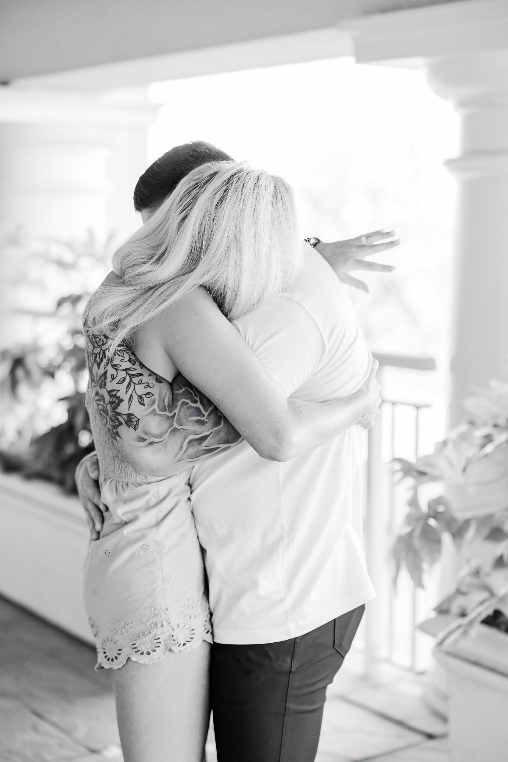 woman hugs groom during Ballantyne Hotel proposal