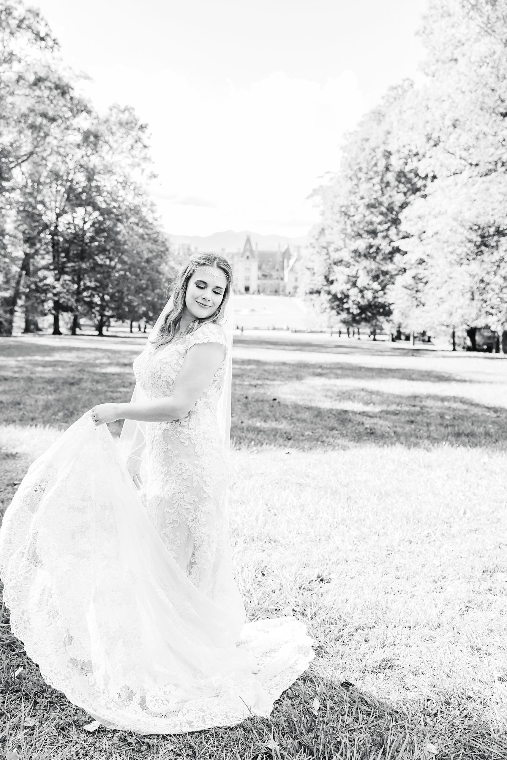 bride twirls wedding gown on the lawn of the Biltmore Estate