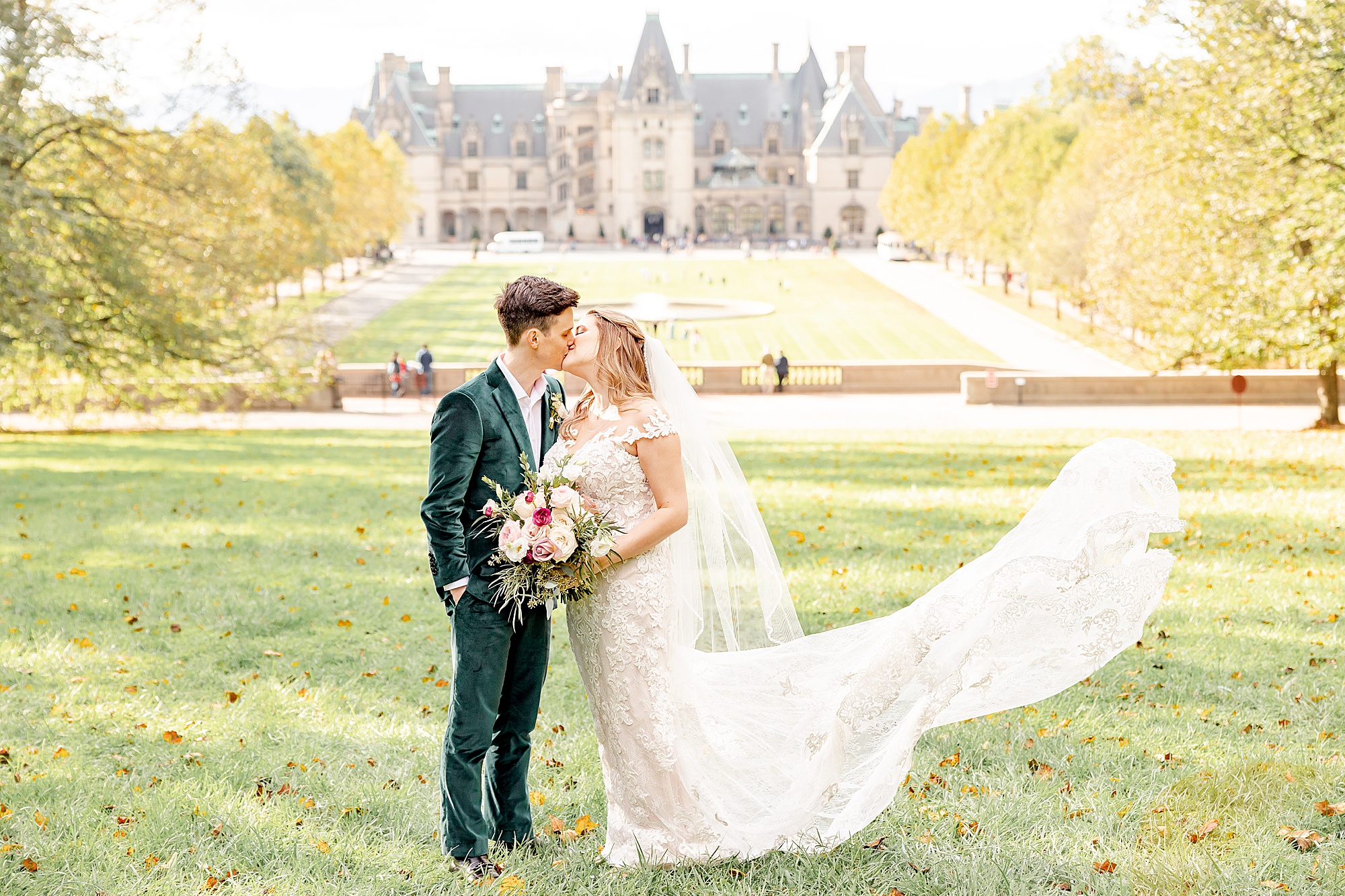 bride and groom kiss on the lawn of the Biltmore Estate