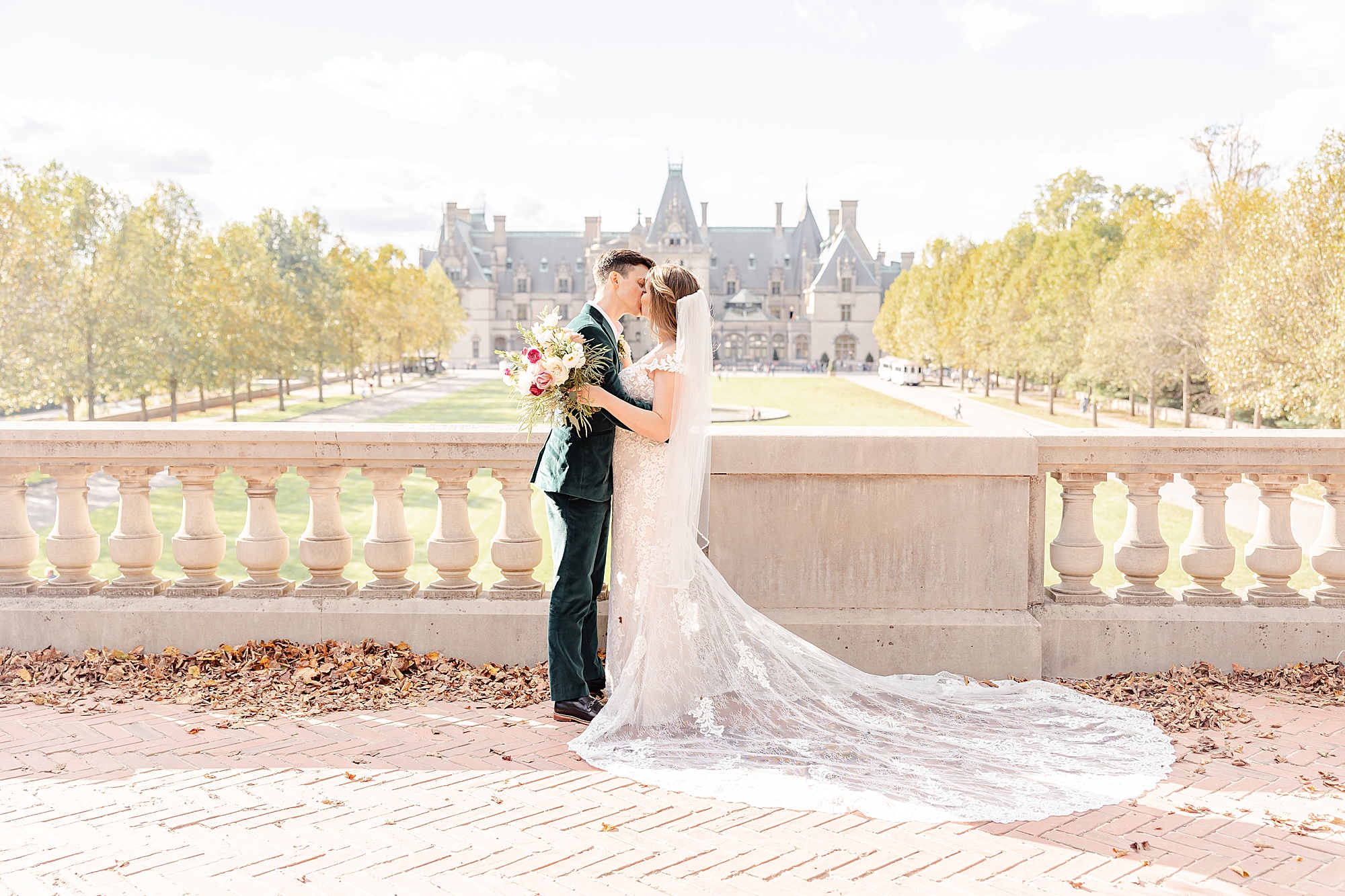 newlyweds kiss on patio of the Biltmore Estate