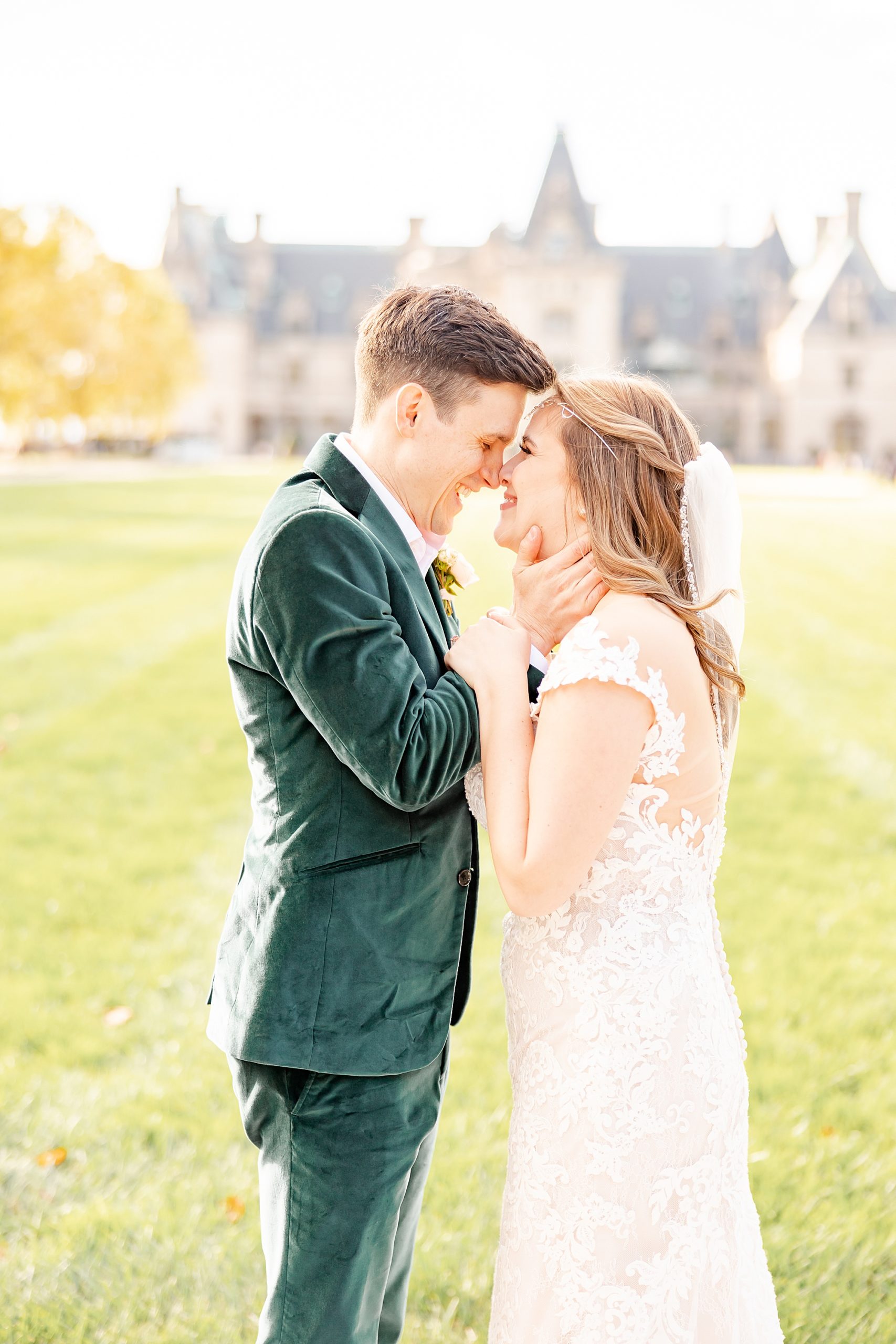bride and groom stand nose to nose during Asheville NC wedding portraits 