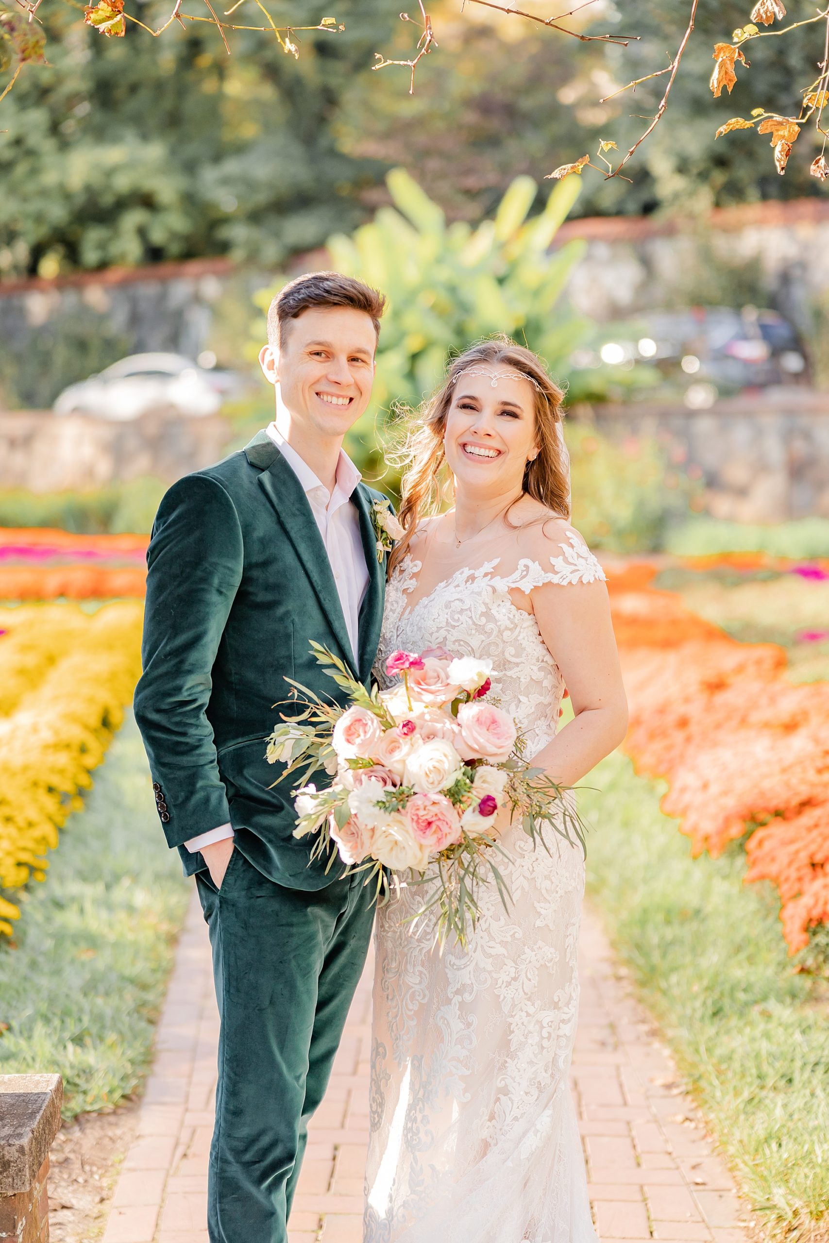 bride and groom pose in colorful garden at the Biltmore Estate