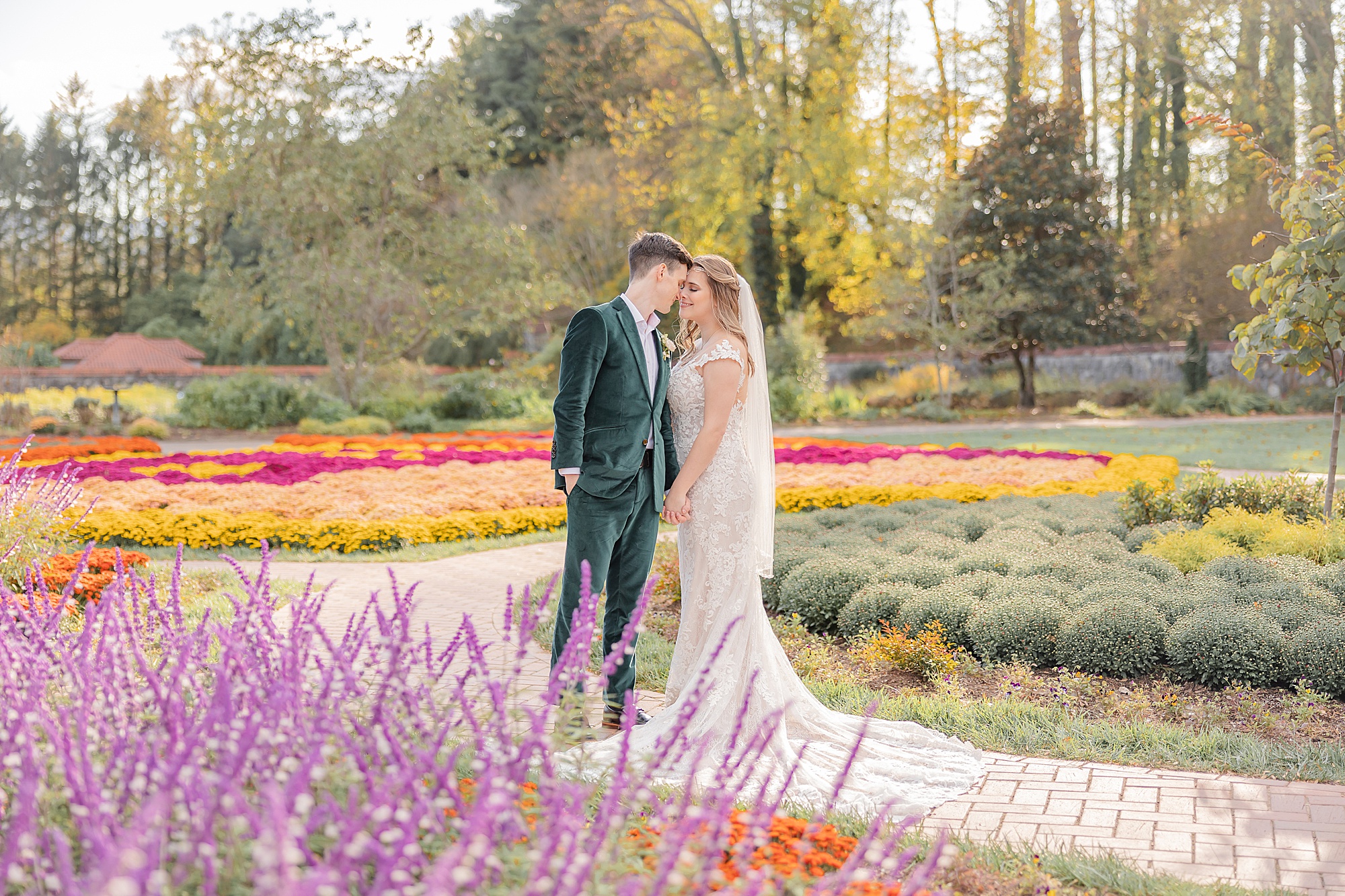 newlyweds pose in garden at the Biltmore Estate