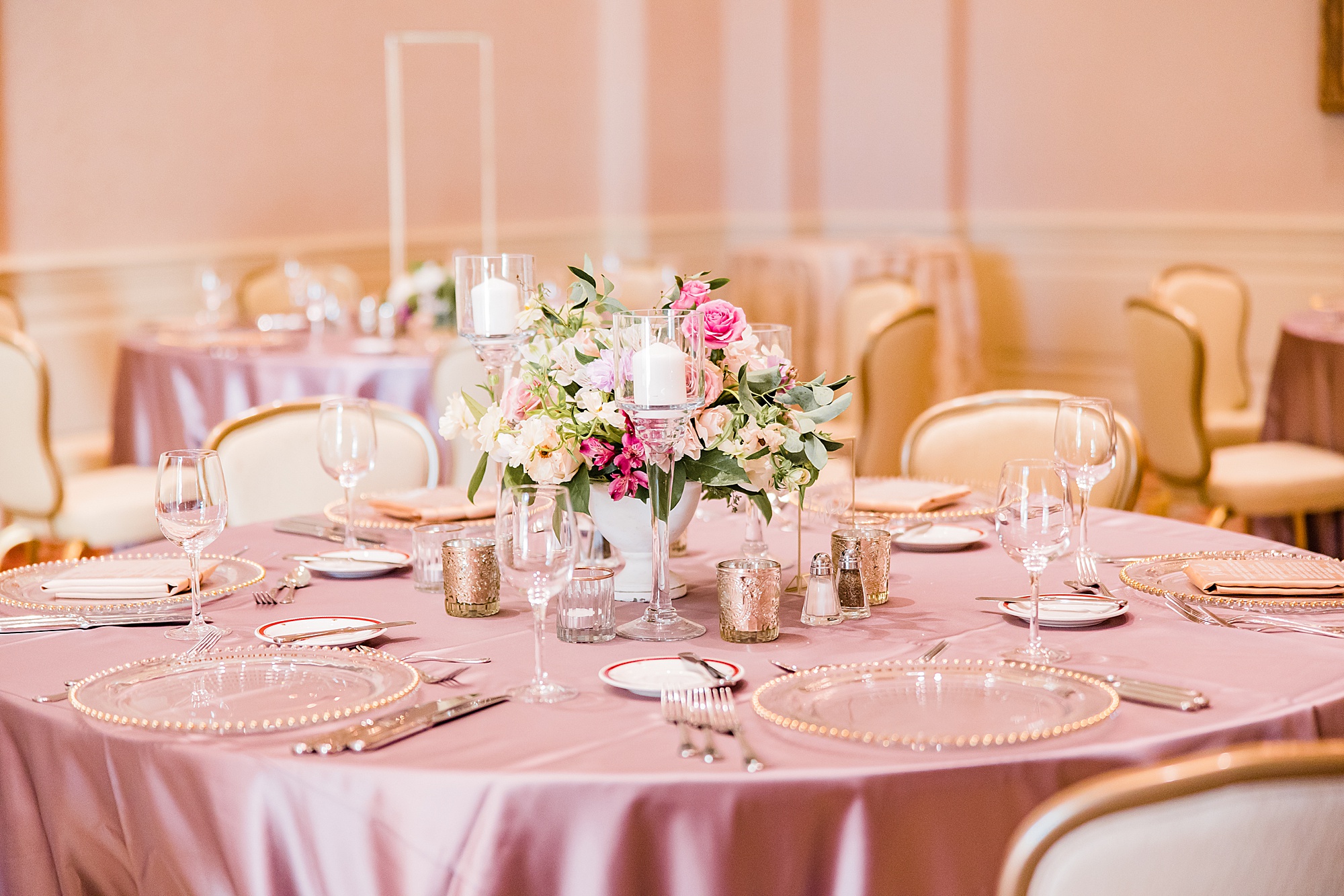 wedding reception place settings with gold and pink details at the Biltmore Village Inn