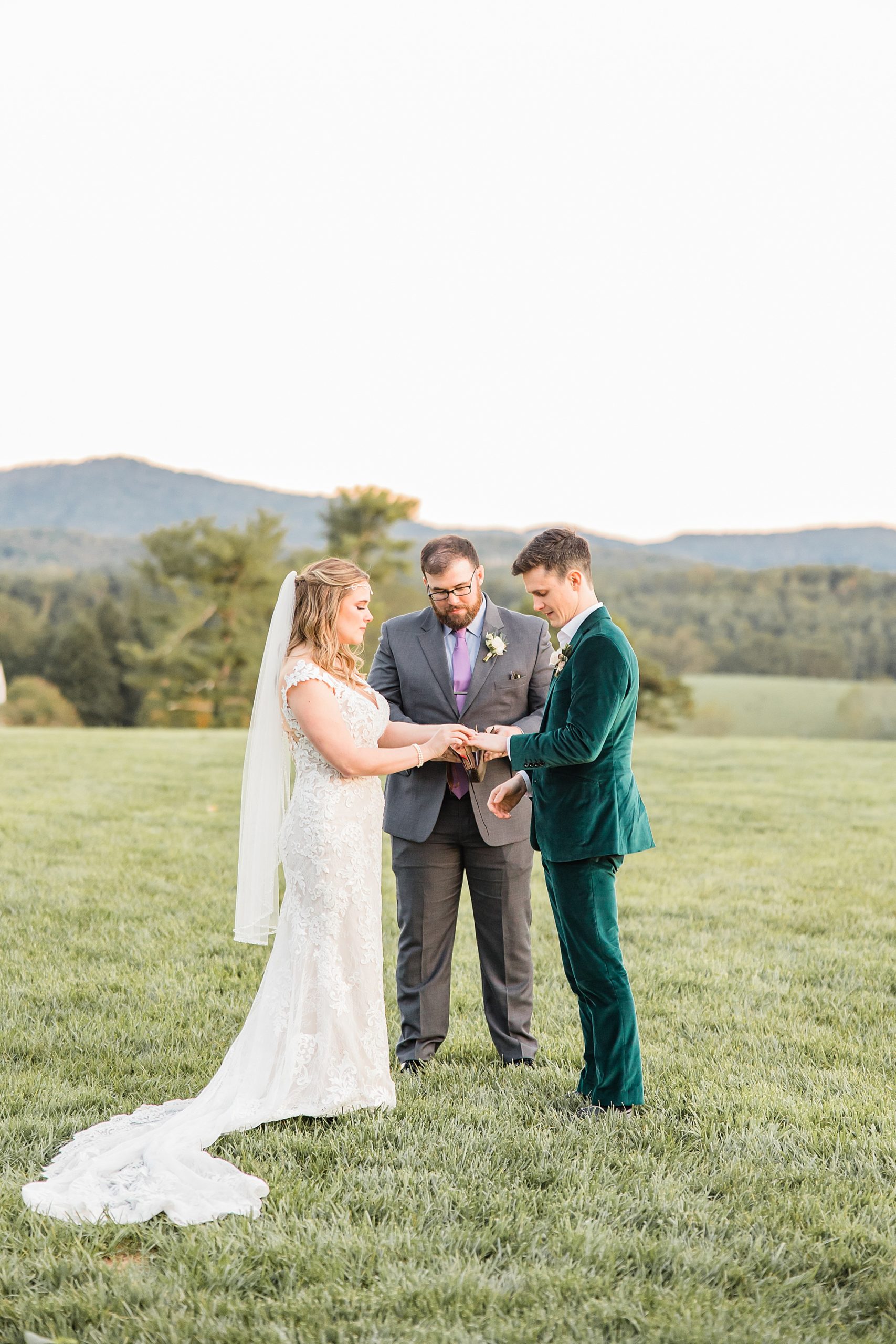 bride and groom hold hands during Asheville NC outdoor wedding ceremony