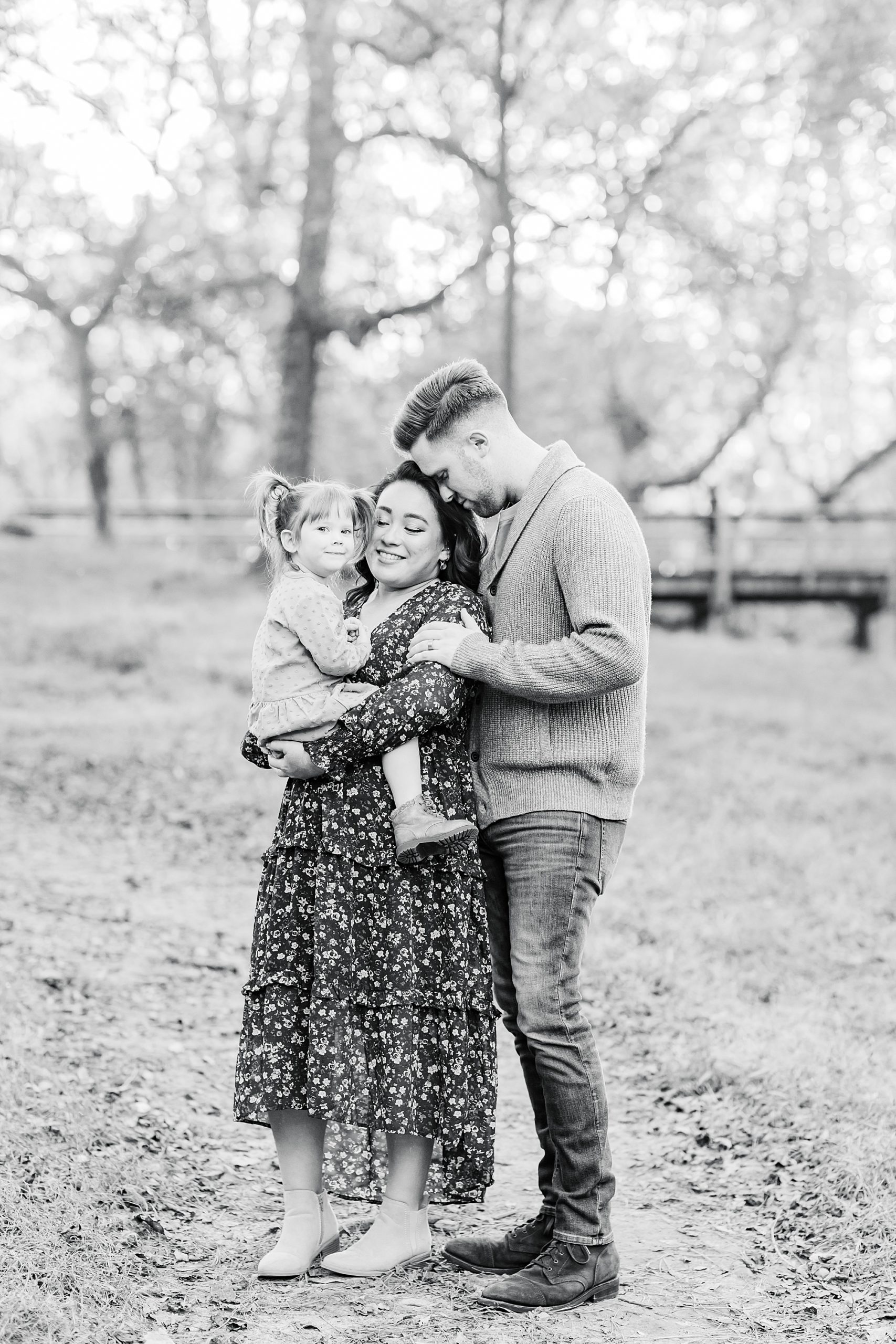parents hug toddler during fall family photos in Georgia