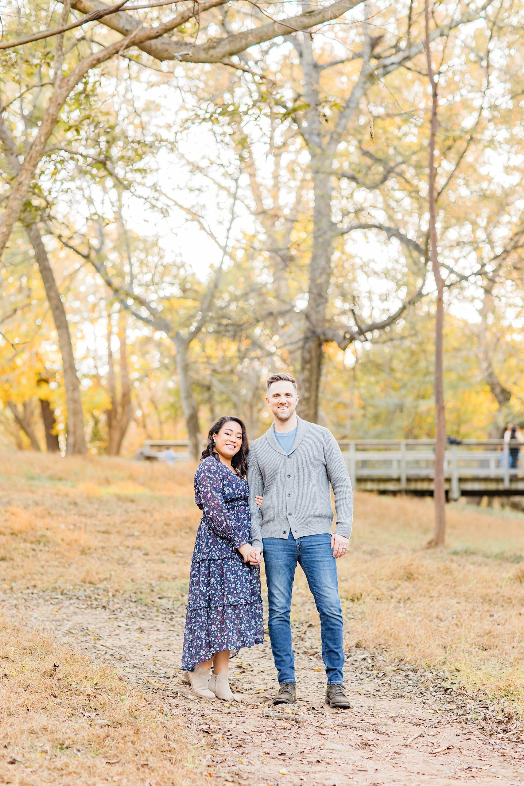 couple stands together during fall family photos in GA