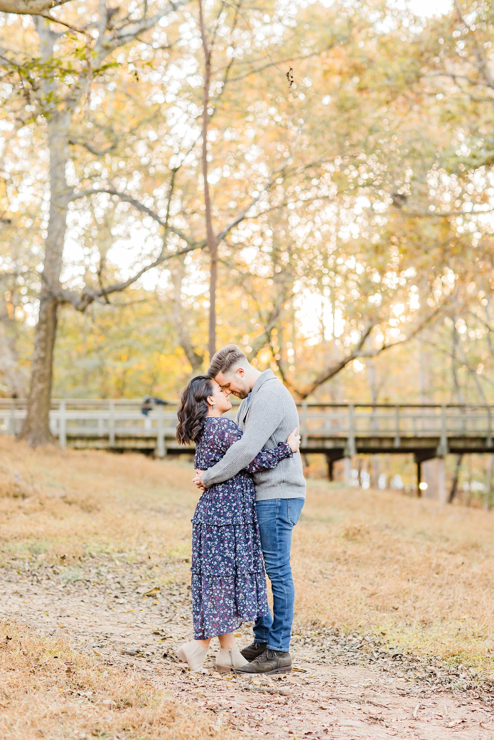 couple stands touching noses during GA family photos