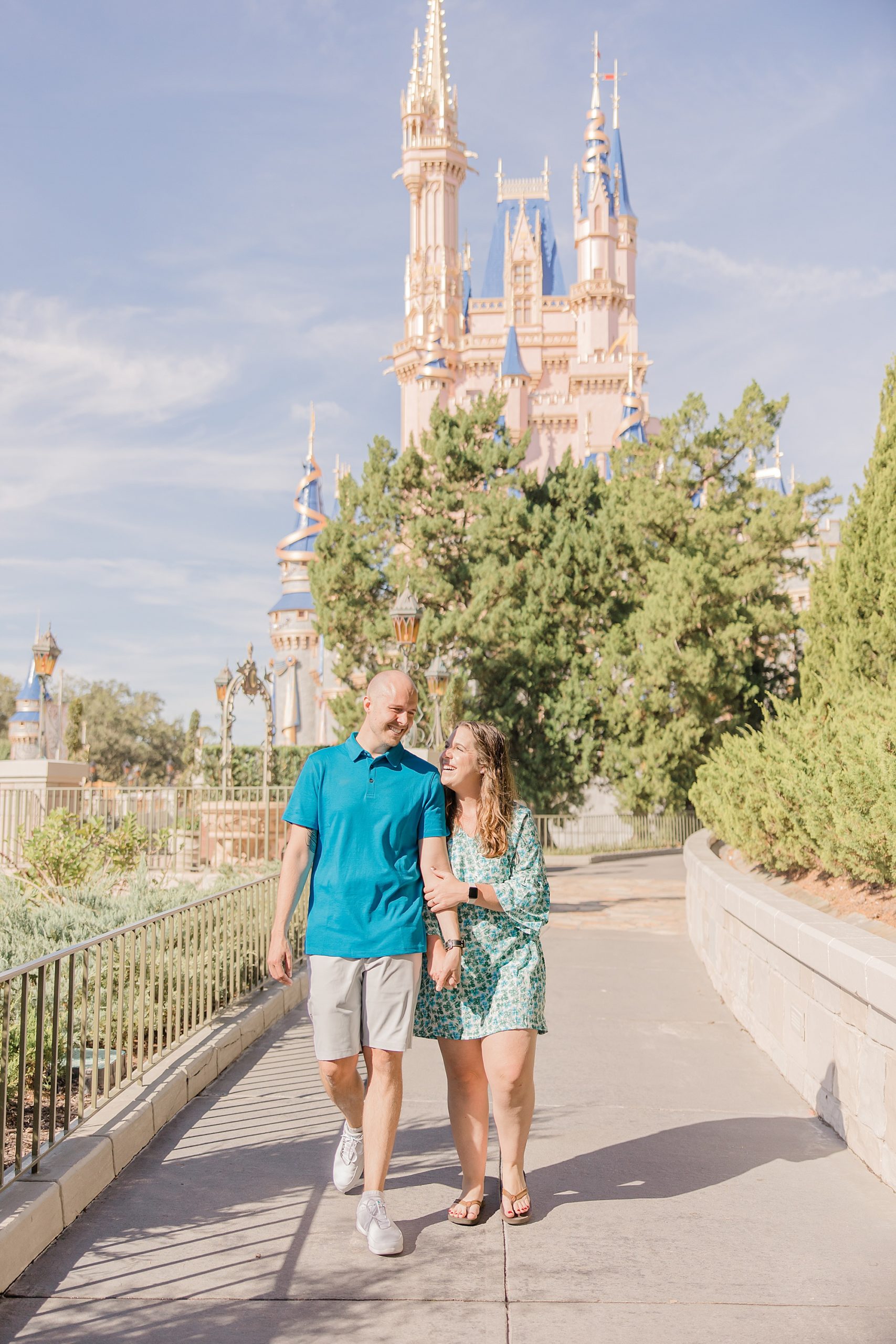 couple walks by Cinderella's Castle