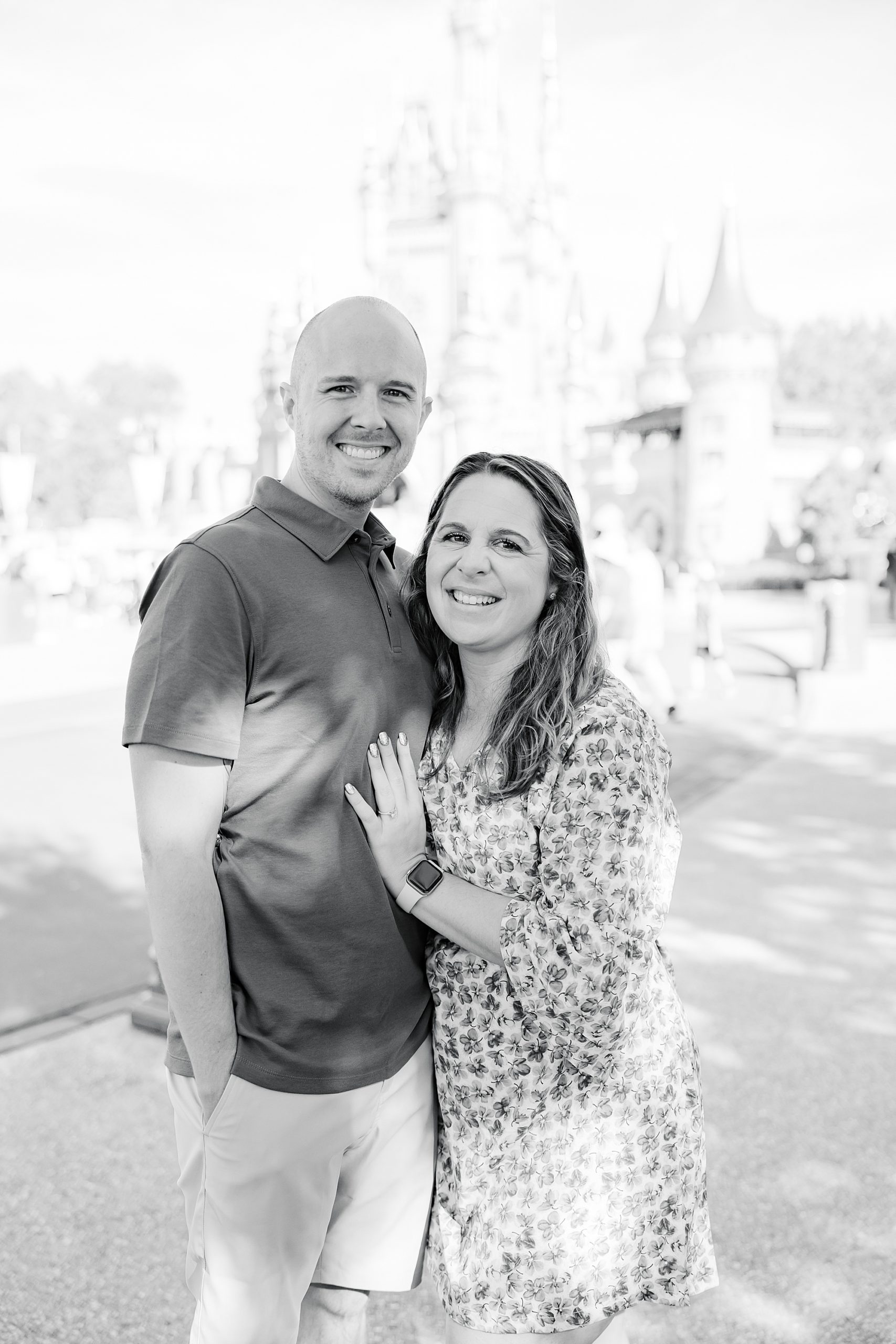 engaged couple stands in Magic Kingdom after proposal 