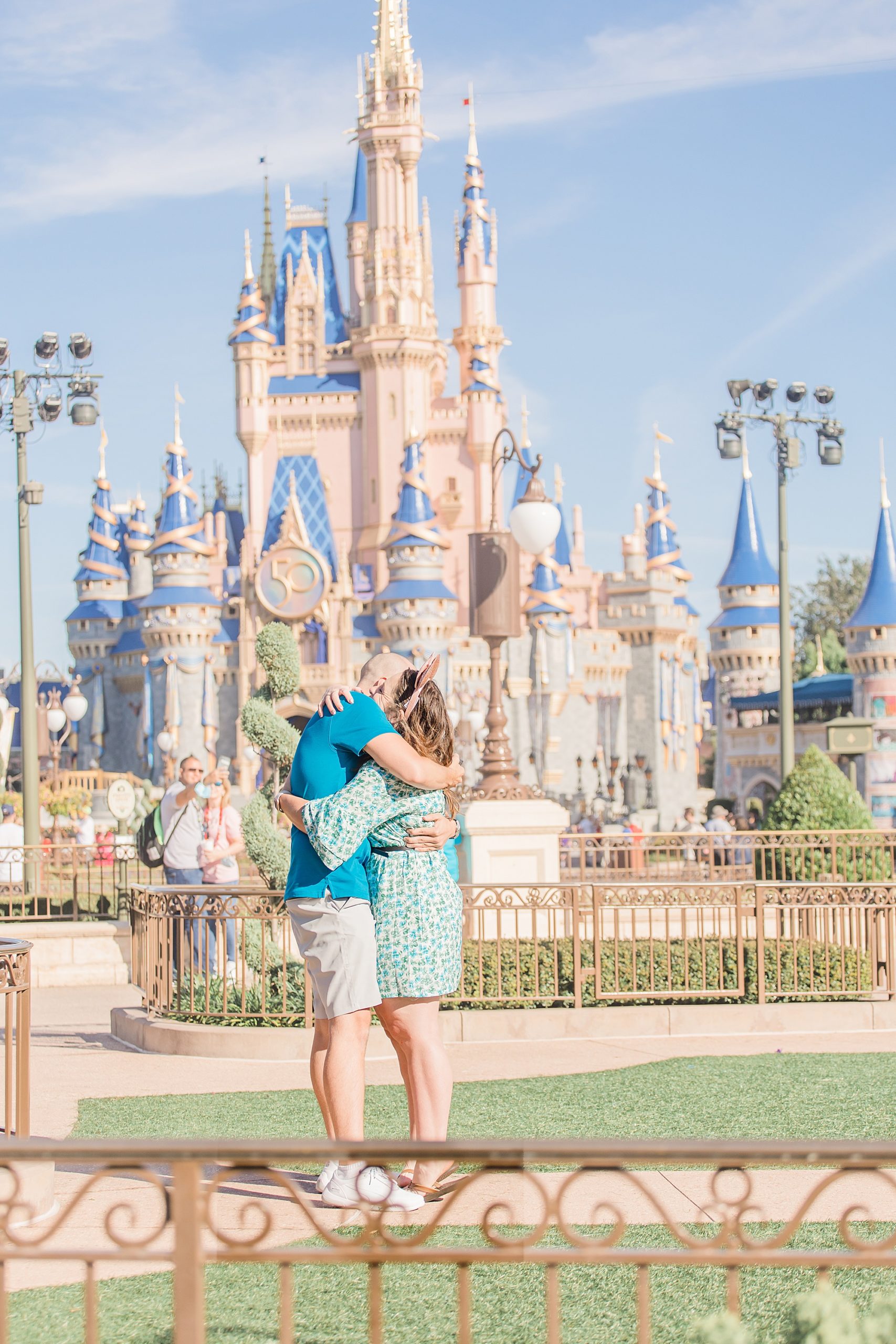 engaged couple hugs after Magic Kingdom Proposal