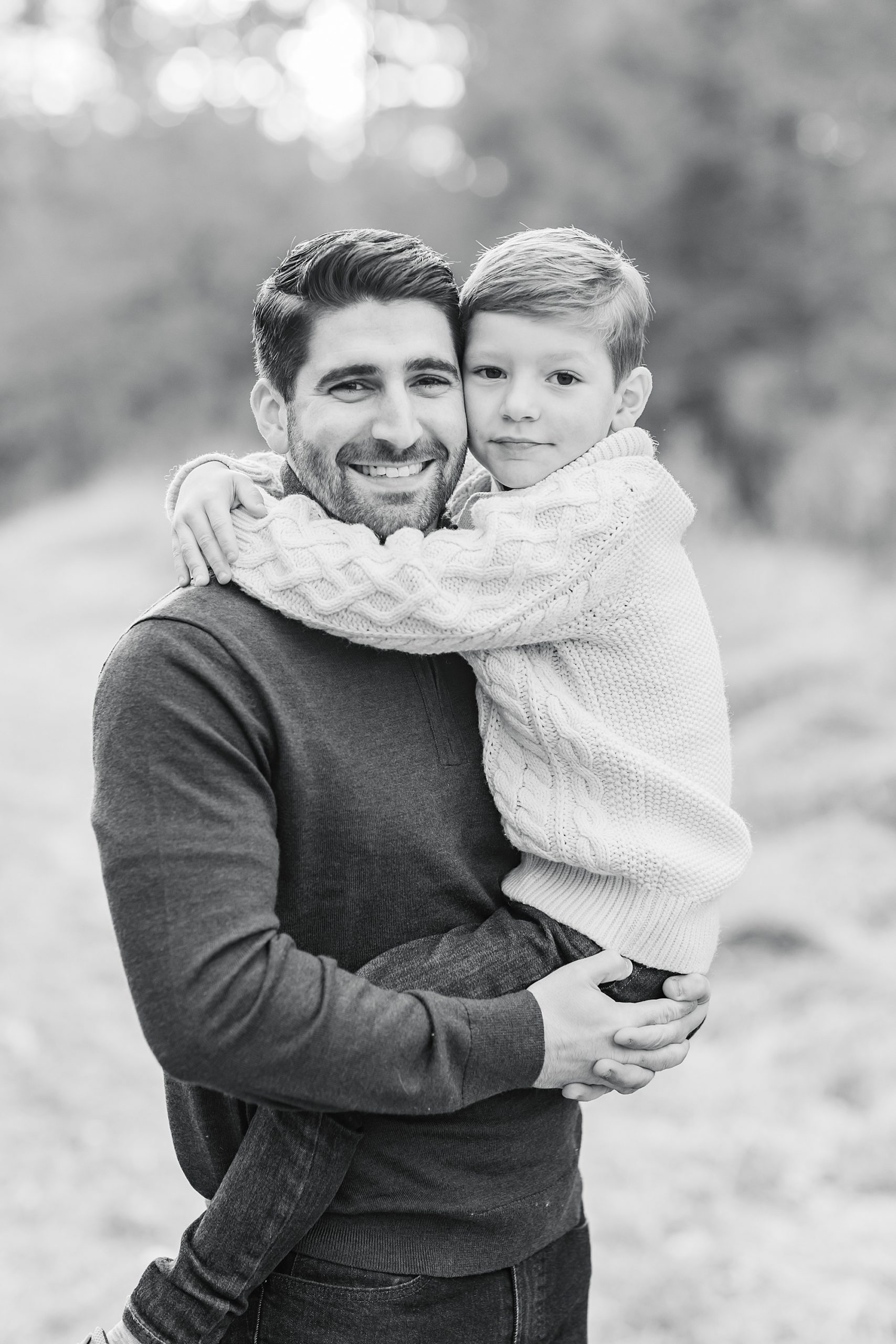 dad hugs son during The Ivy Place Venue family portraits