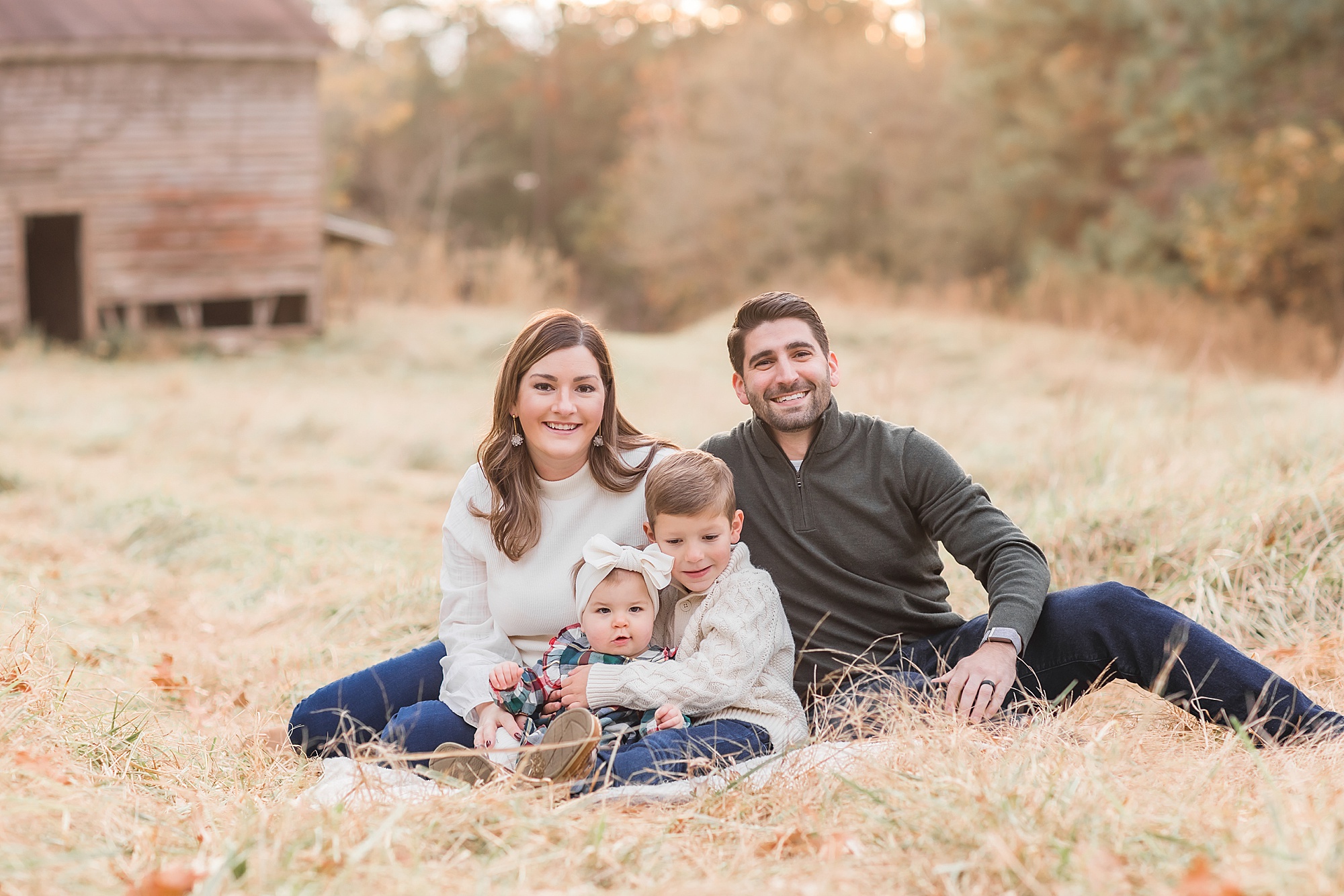 family of four snuggles together on blanket during SC family photos