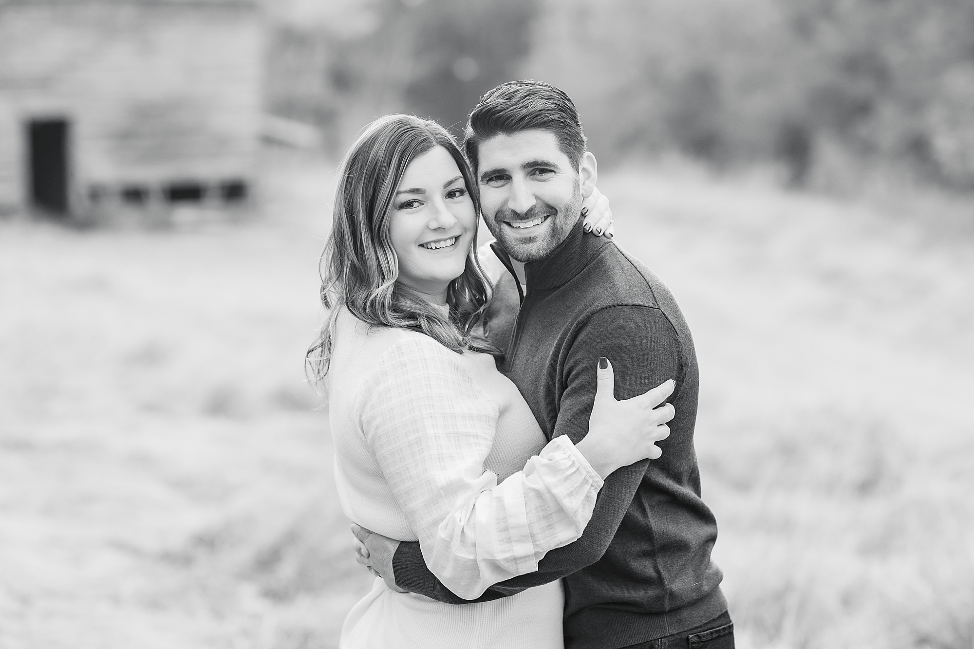 husband and wife hug during The Ivy Place Venue family portraits