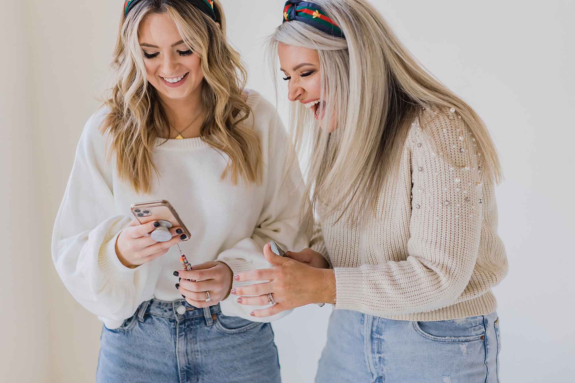 women laugh at phone during branding photos