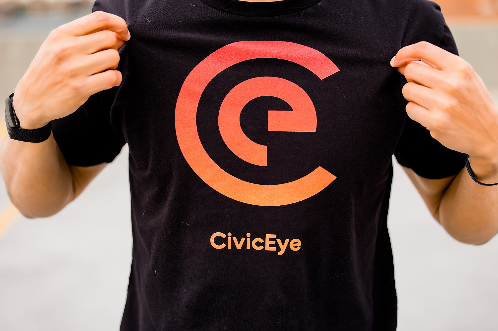man shows off CivicEye logo during Charlotte headshots