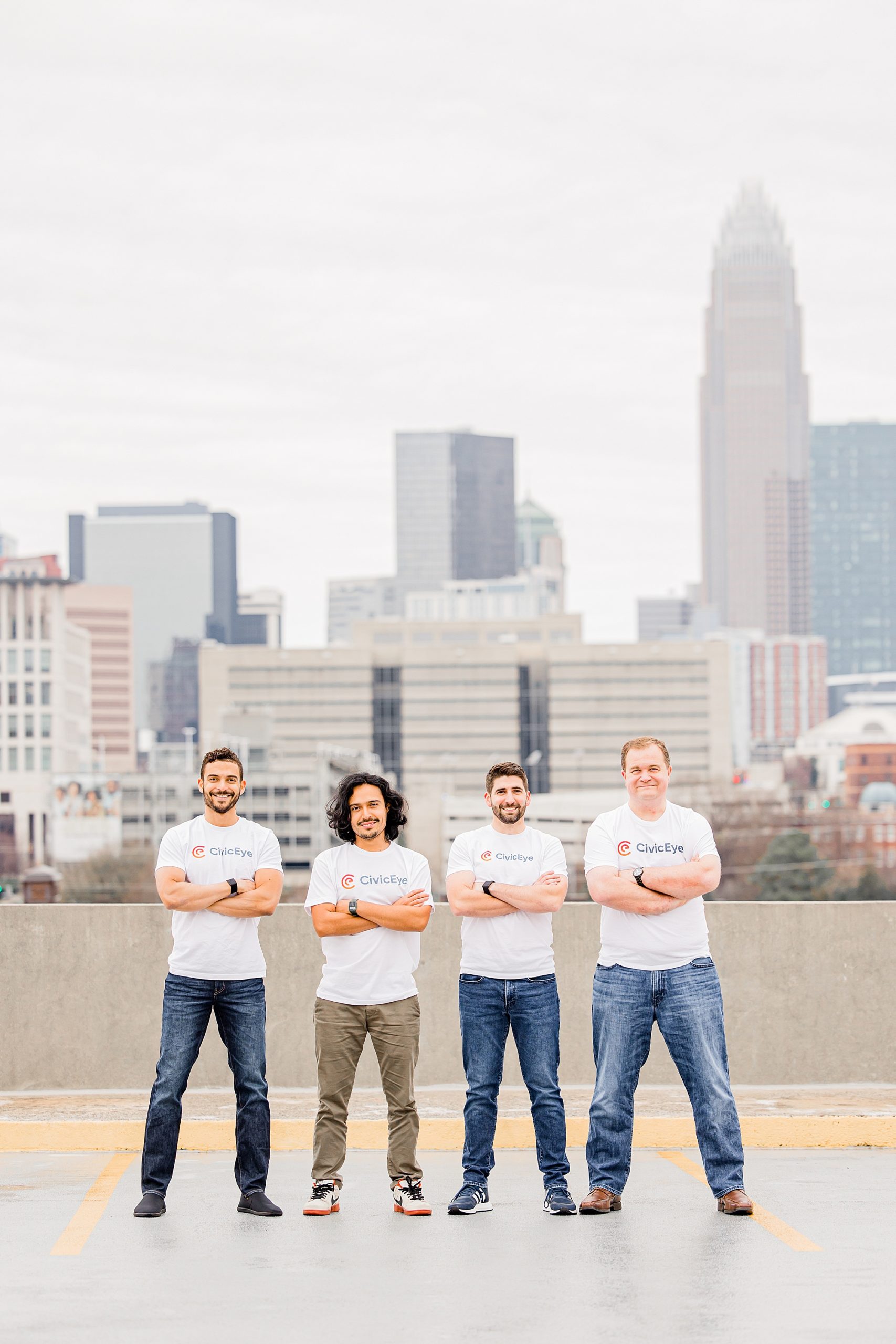 business owners stand in white t-shirts with arms crossed during Charlotte headshots