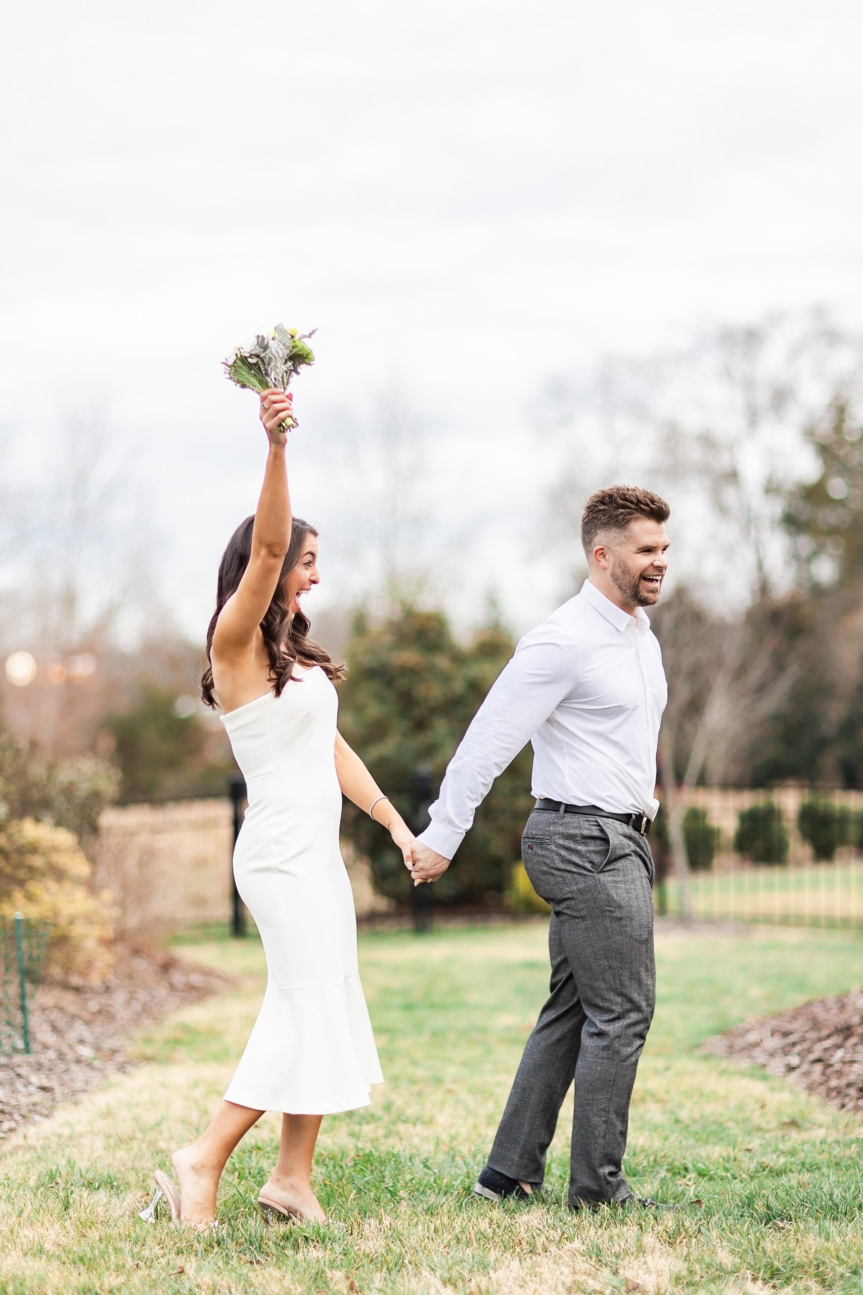 bride cheers while walking with groom at home