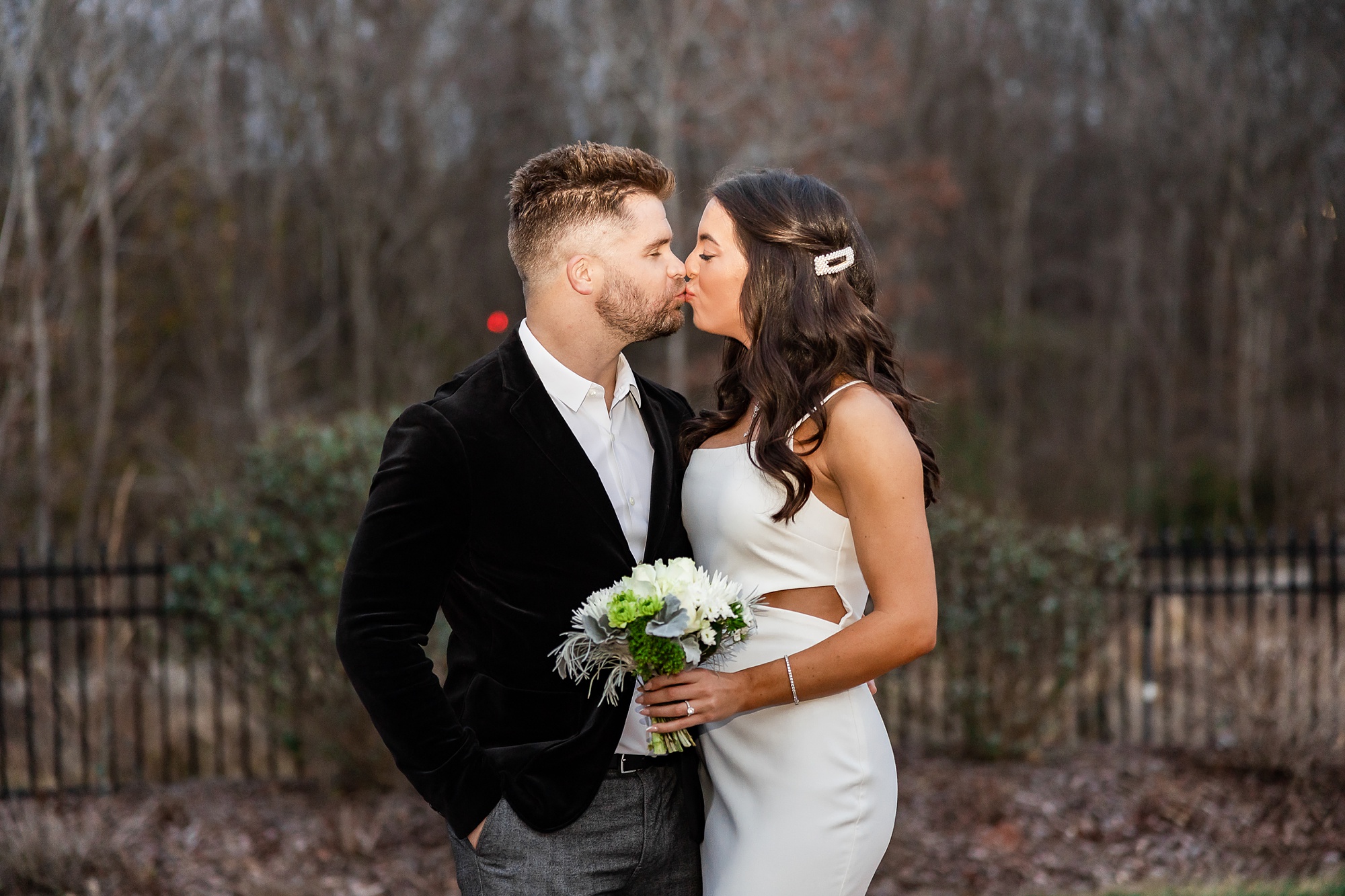 newlyweds kiss on patio during intimate at-home elopement