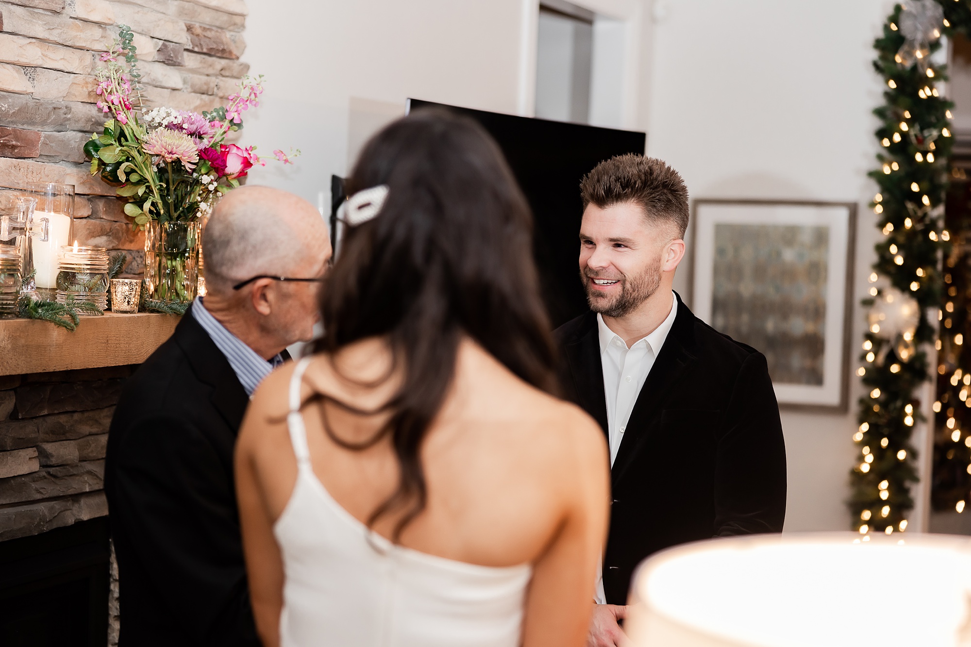 groom listens to ceremony at home during intimate at-home elopement