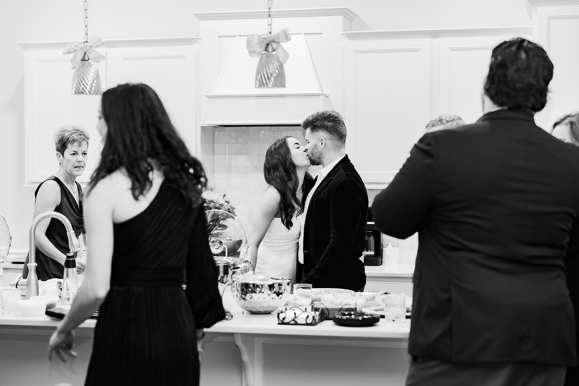 couple kisses in kitchen after intimate at-home elopement