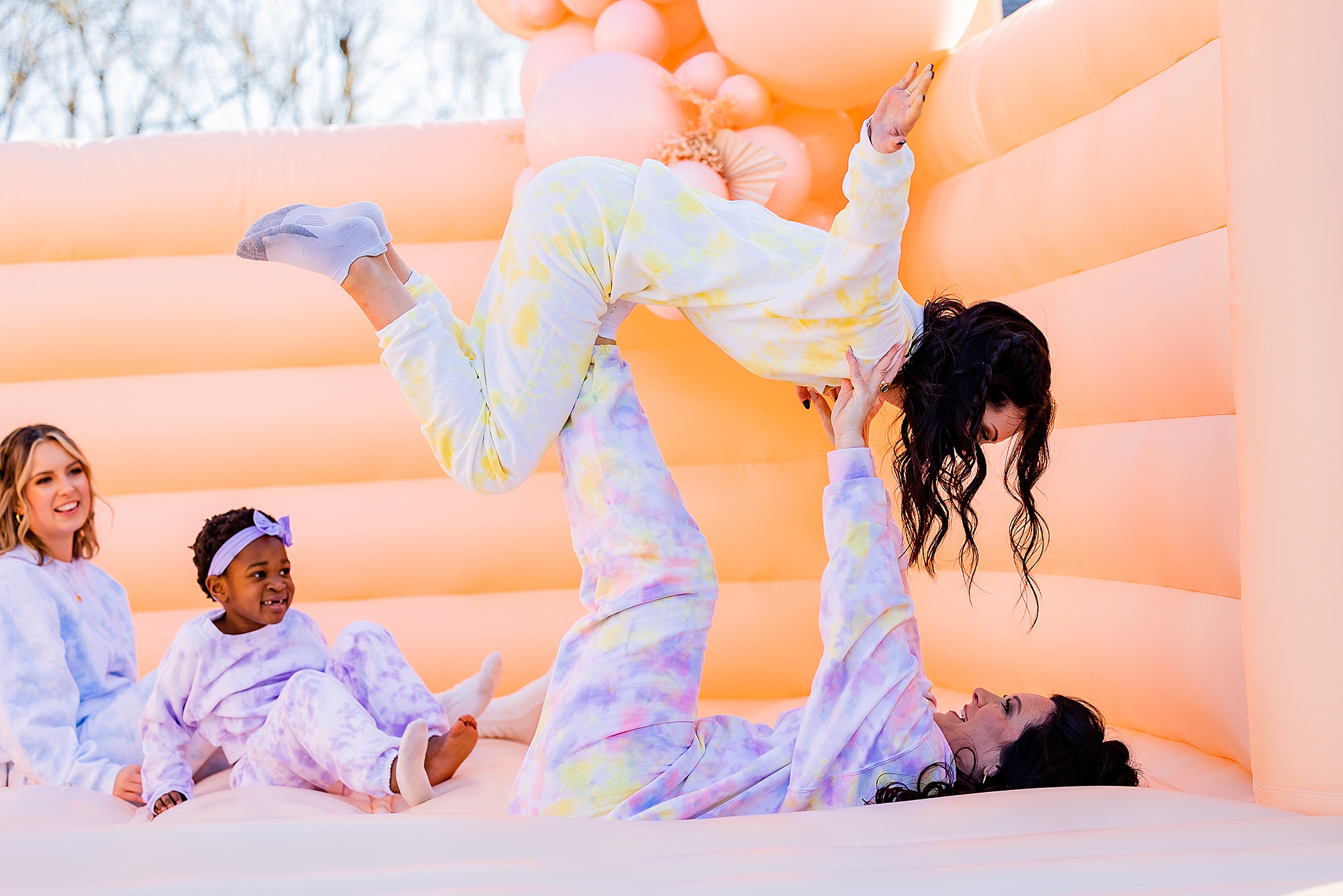 family plays on bounce house during Charlotte Branding Portraits