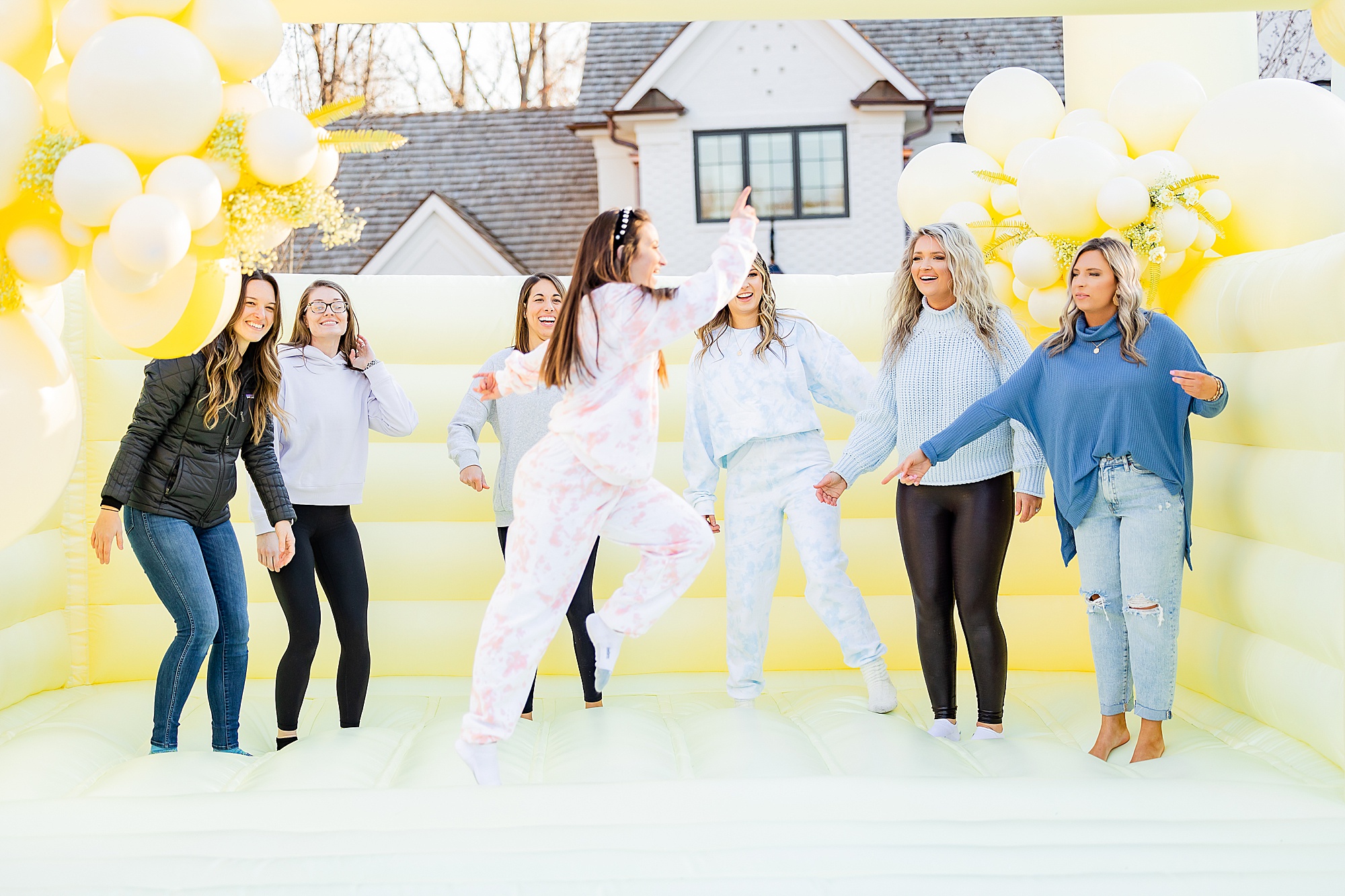 women jump on yellow bounce house during Charlotte Branding Portraits