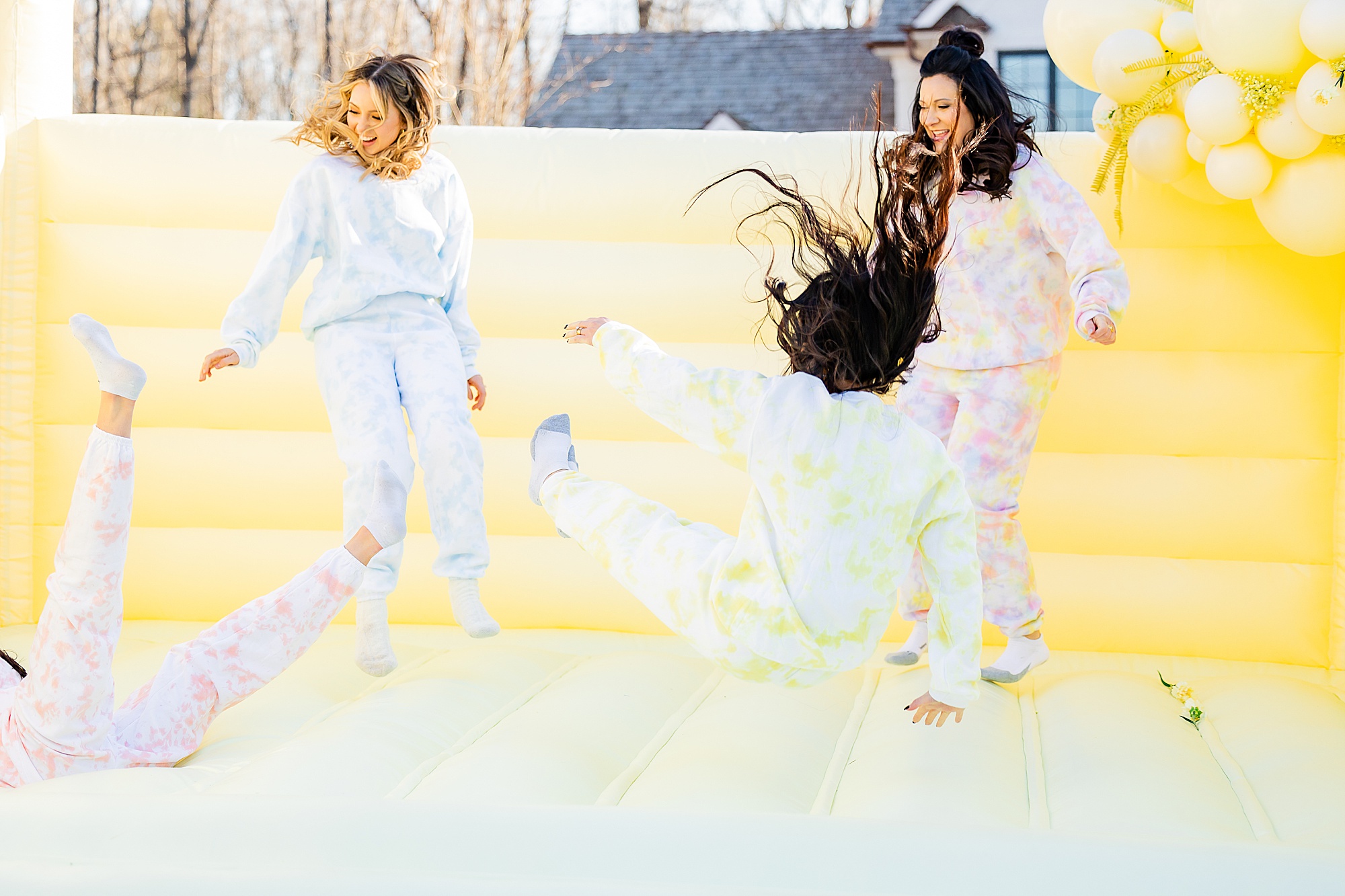 women bounce during branding session for bounce houses