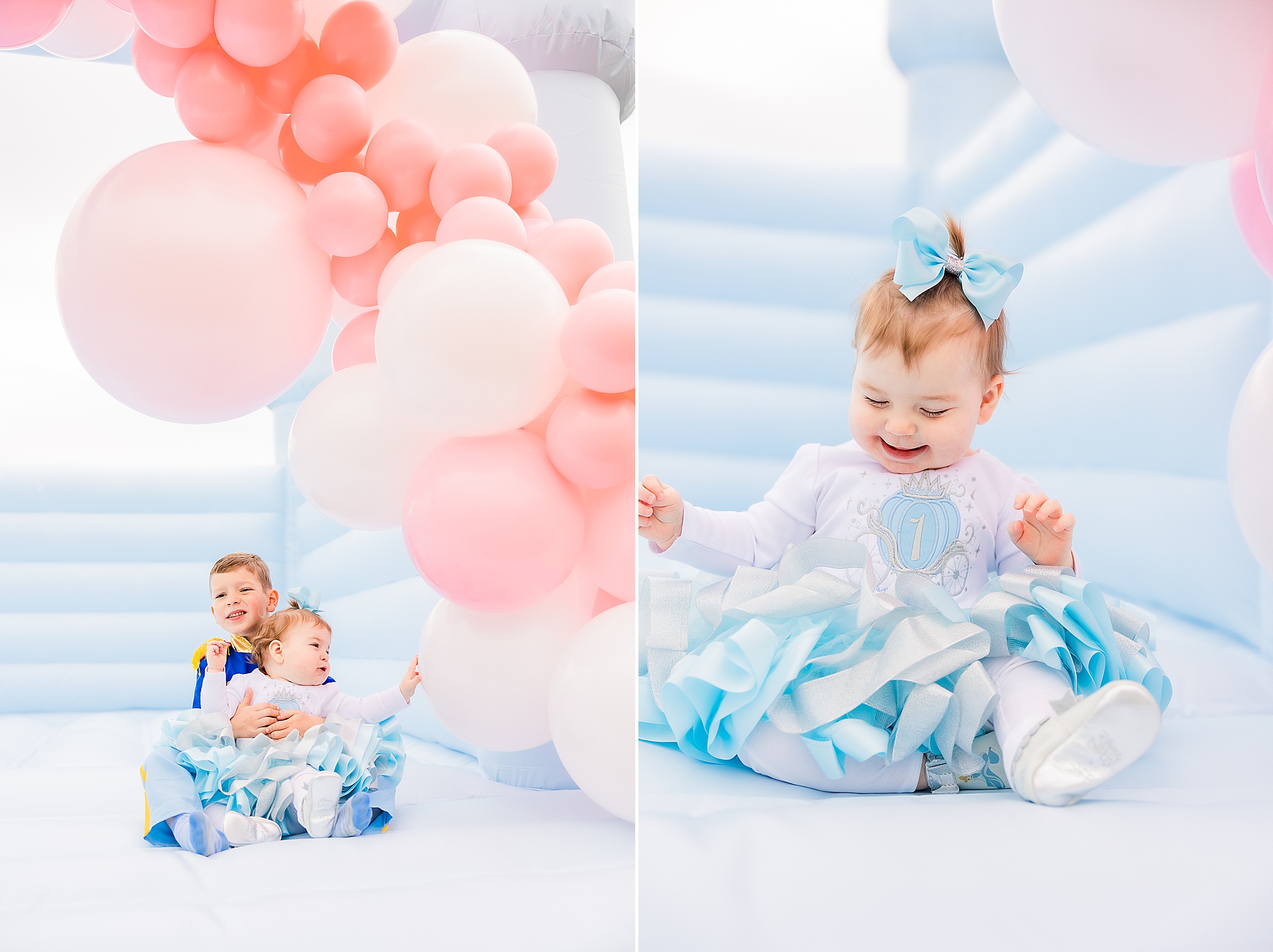 brother holds sister in blue bounce house during Princess themed first birthday party