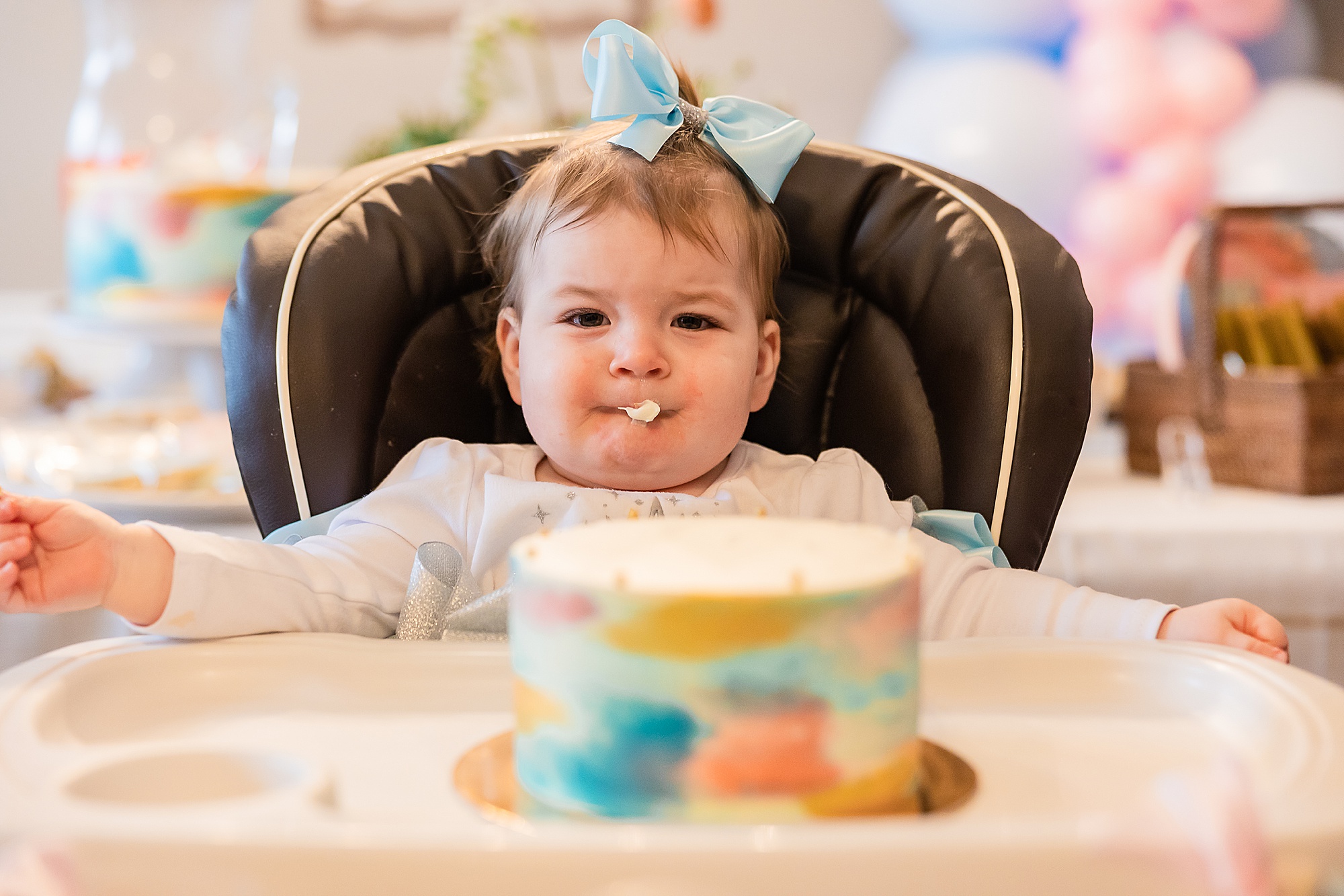 baby eats icing during Princess themed first birthday party