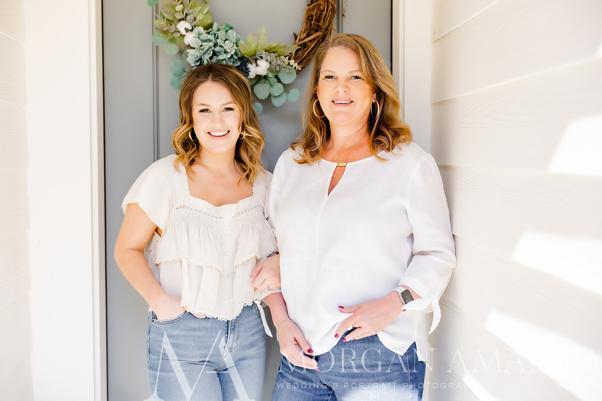 mom and daughter real estate team pose during branding session