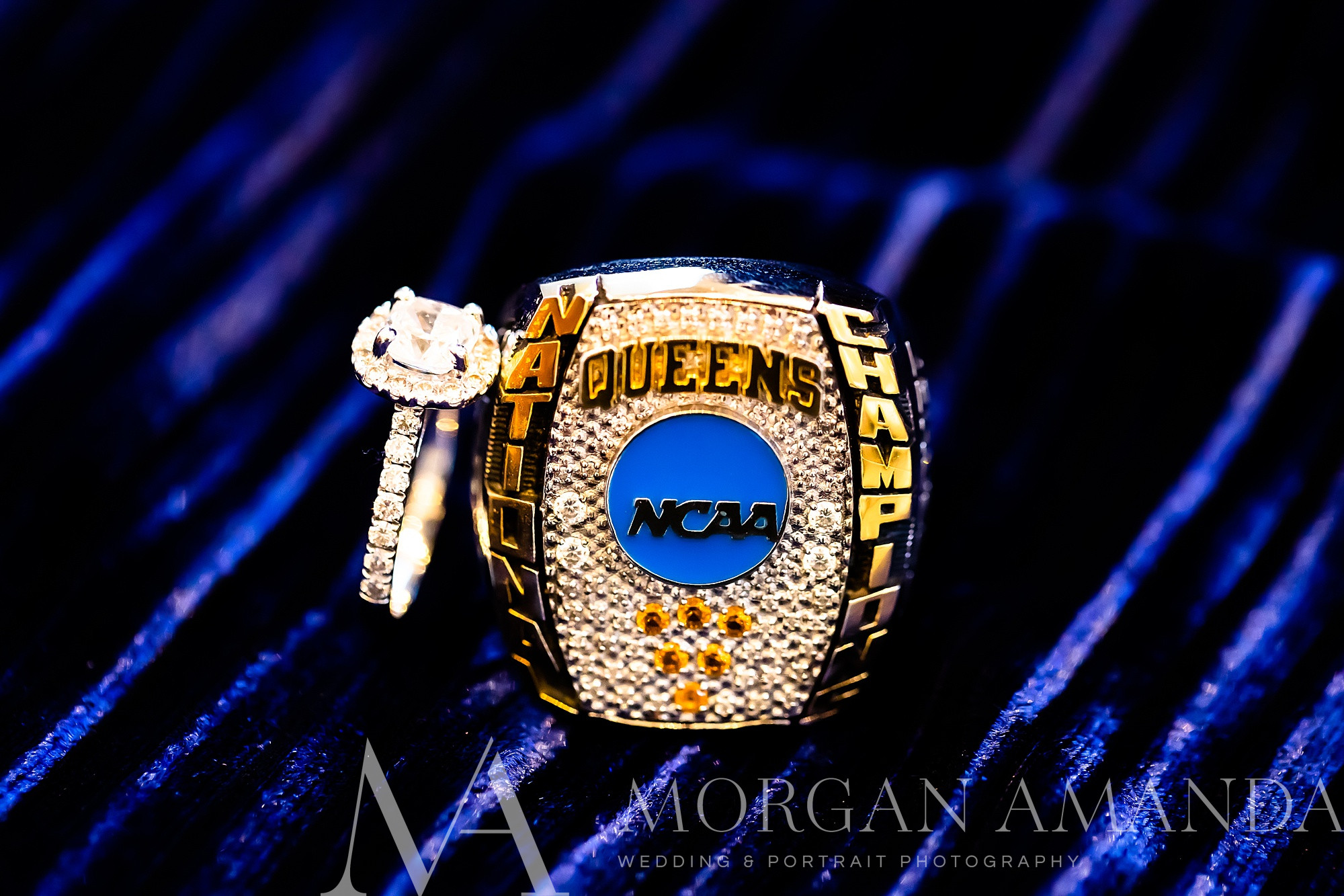 engagement ring and Queens University NCAA Ring on purple velvet