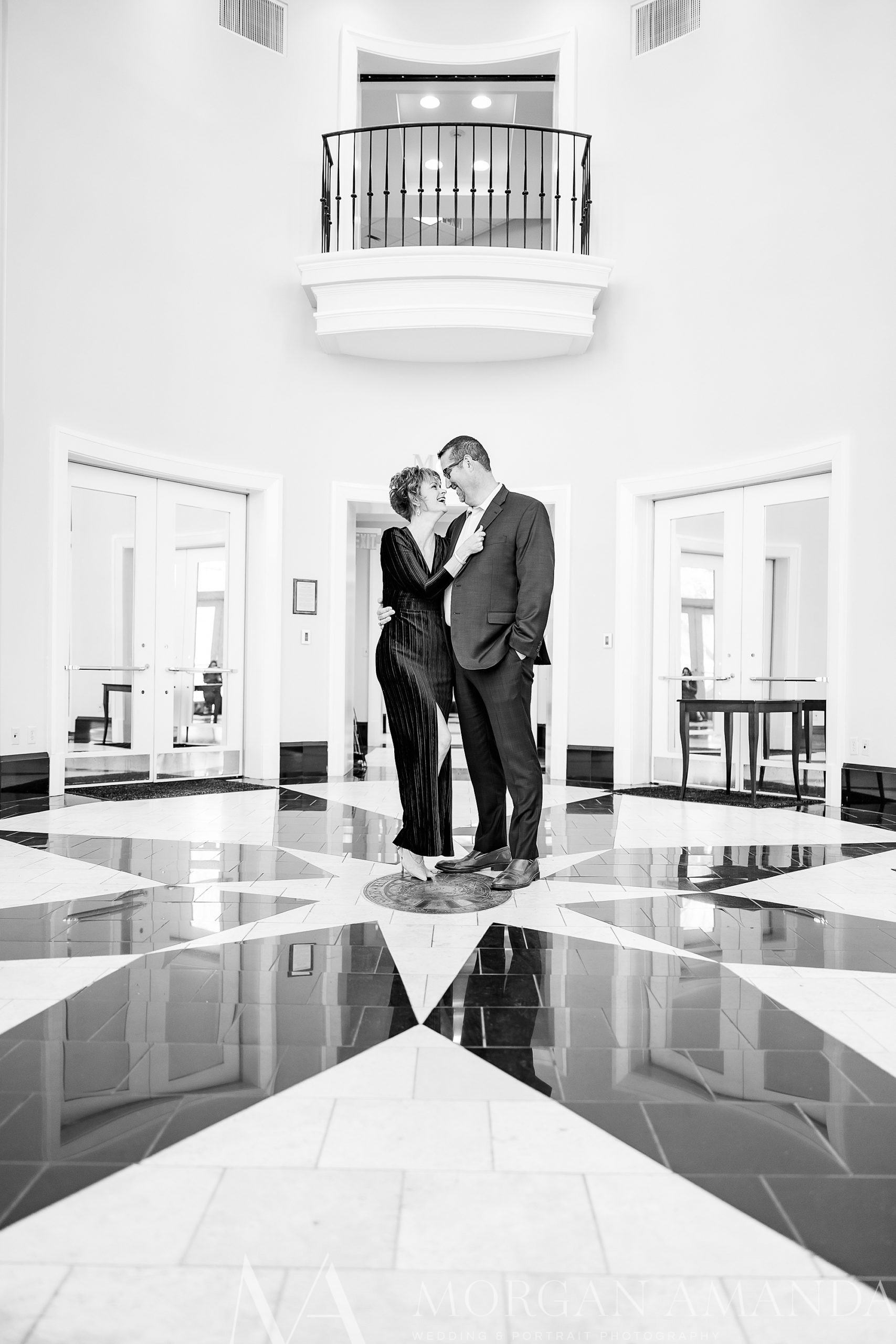 engaged couple poses in office building of Charlotte NC campus