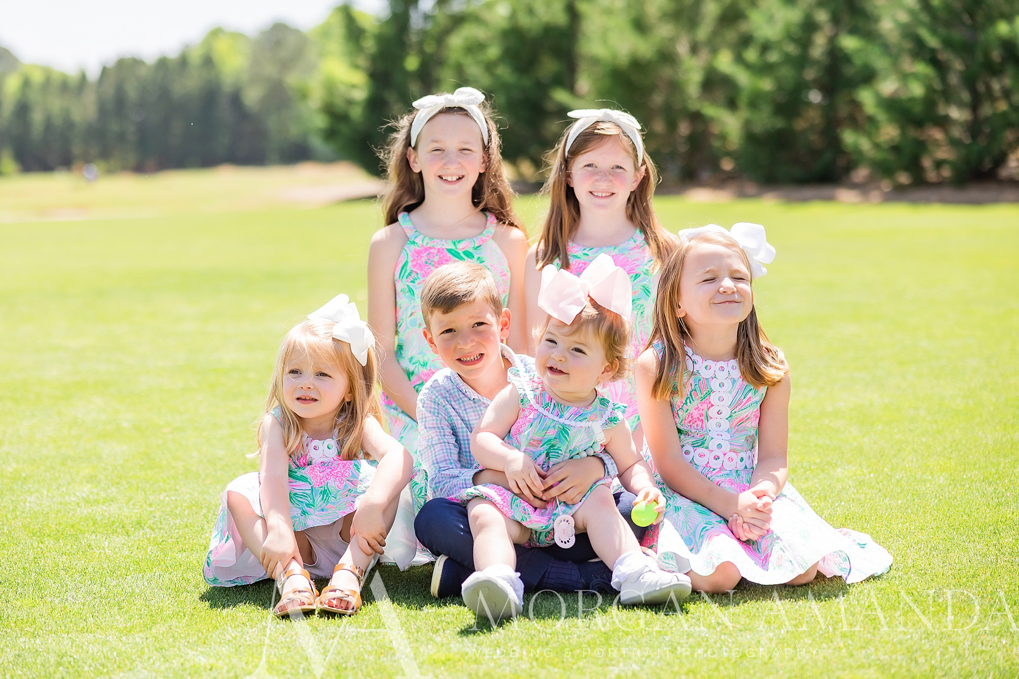 six cousins sit together on lawn at Providence Country Club