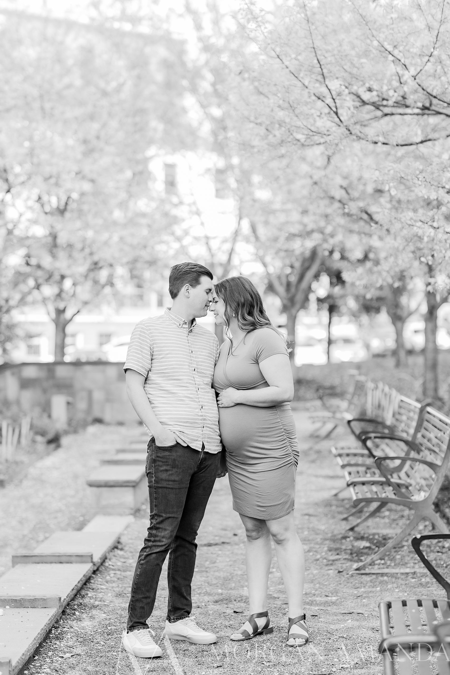 expecting parents stand together during Romeare Bearden Park maternity session