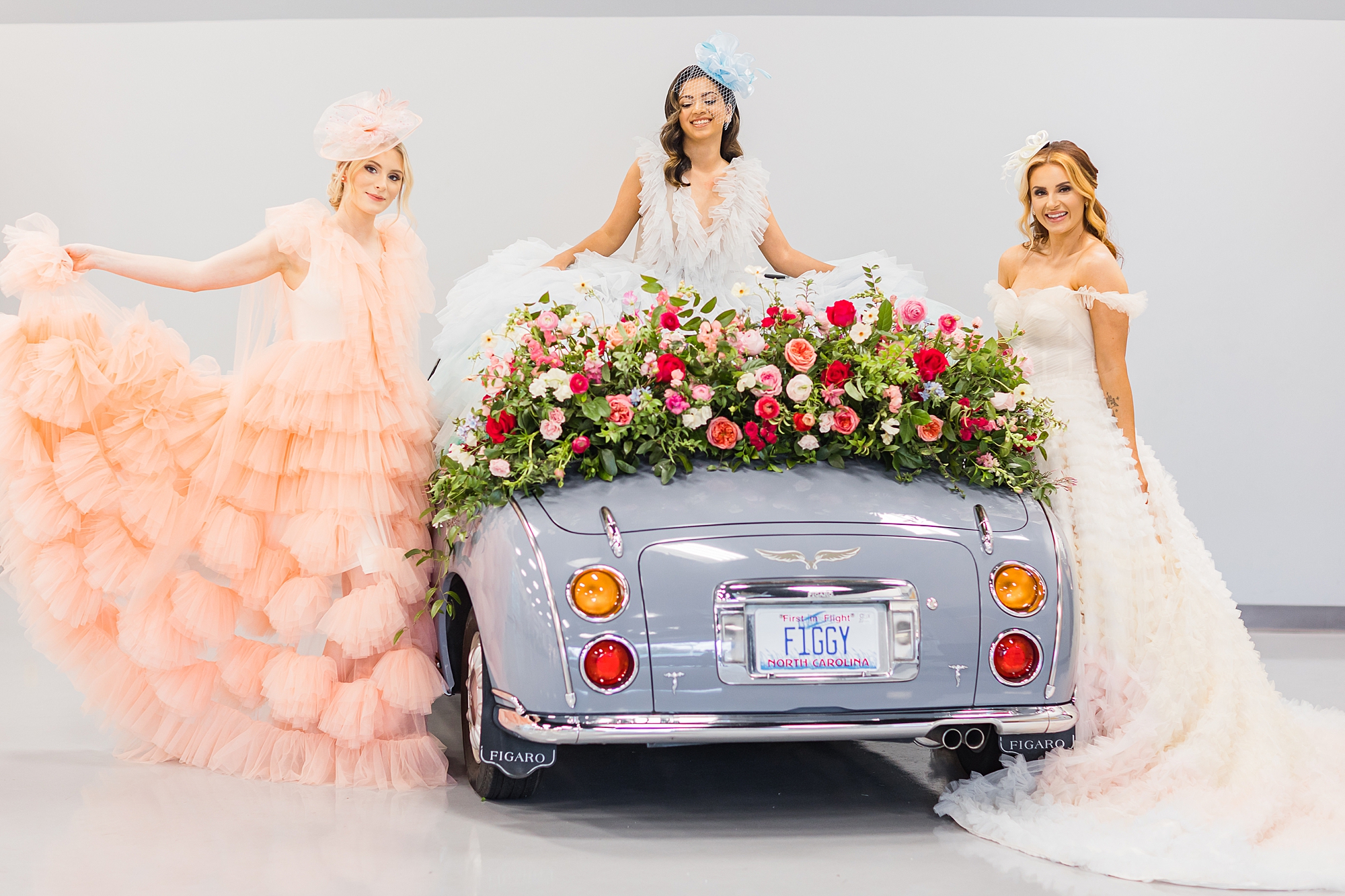woman pose next to purple car during springtime wedding styled shoot
