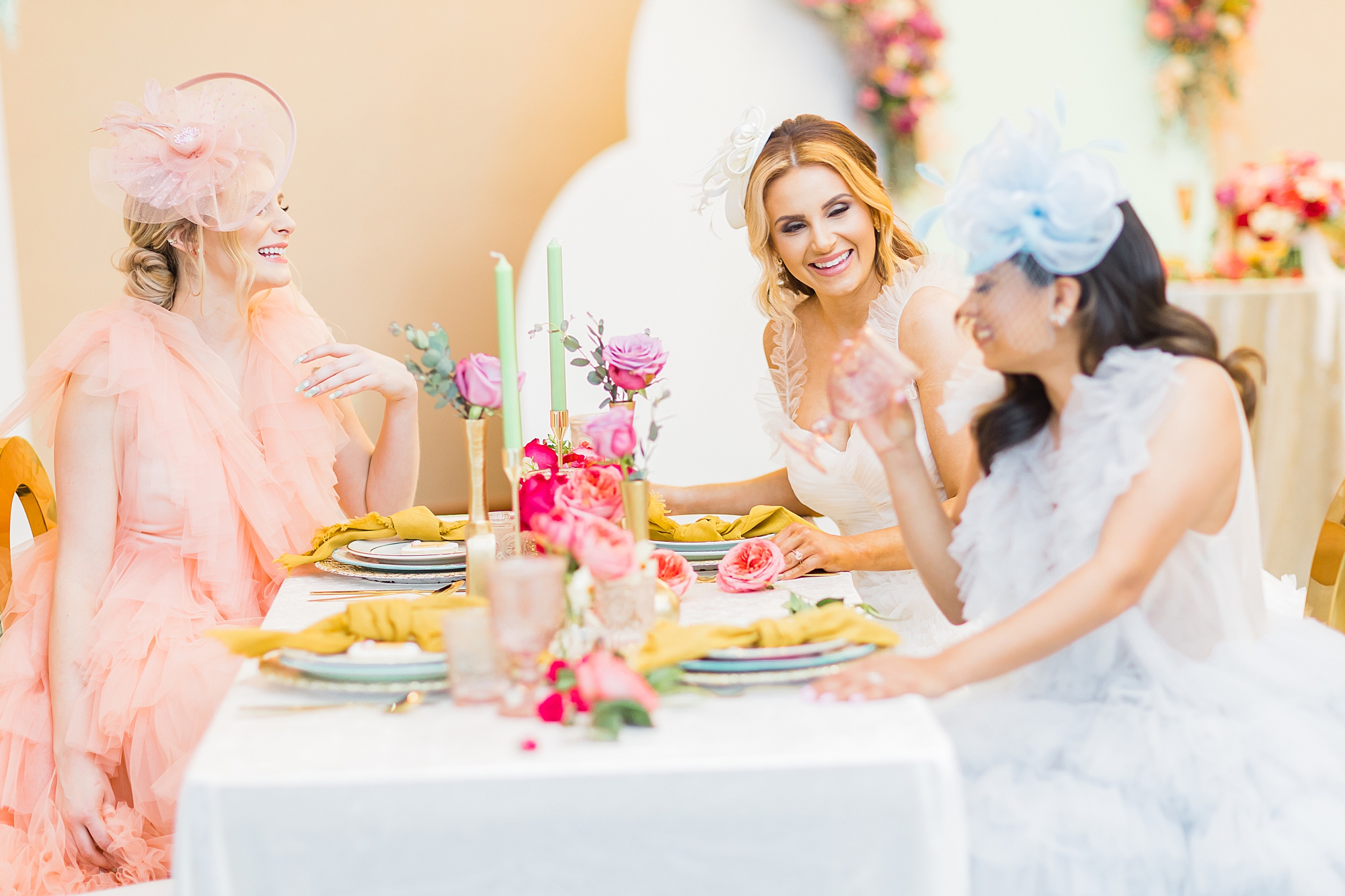 women laugh during wedding reception inspired by Kentucky derby