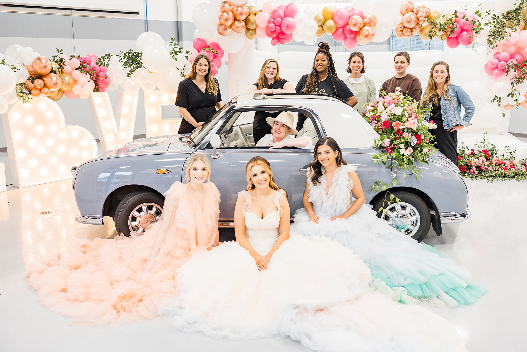 vendors pose with Charlotte the Figgy after springtime wedding styled shoot