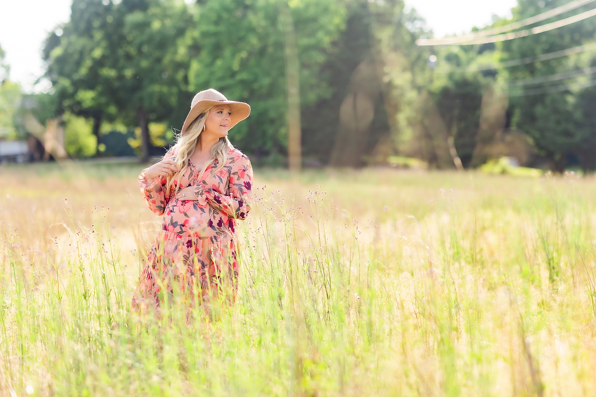 maternity portraits in Charlotte field for mother wearing floppy hat