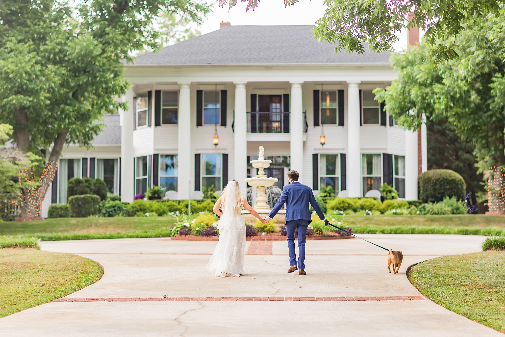 bride and groom walk with dog on GA wedding day